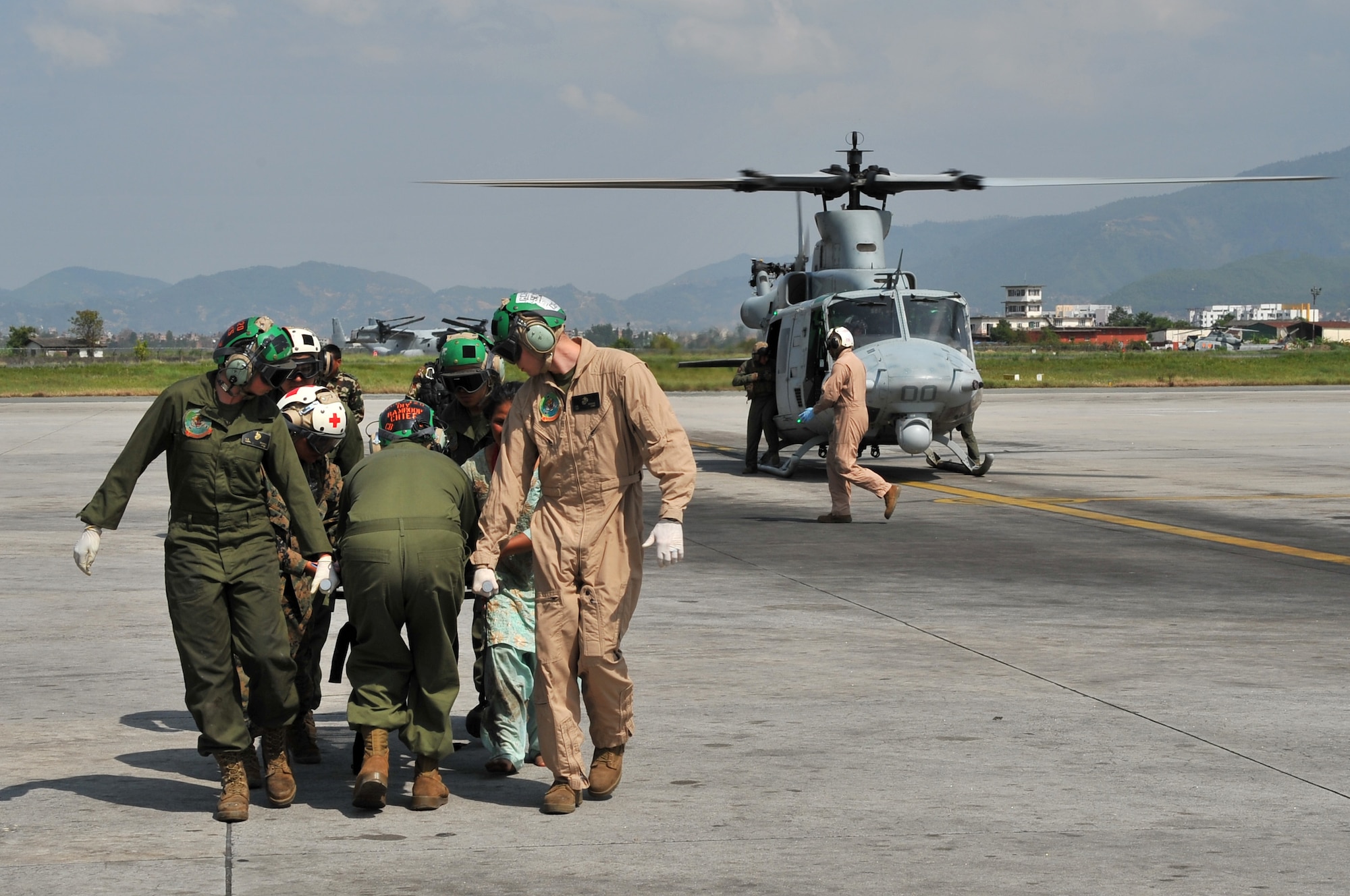 U.S. Marines and Nepalese army soldiers transport an earthquake victim from a UH-1 Huey helicopter for medical care at the Tribhuvan International Airport in Kathmandu, Nepal, May 12, 2015. Joint Task Force-505 members worked with the Nepalese army to triage, treat and transport patients after a 7.3 magnitude earthquake struck the same day following a 7.8 magnitude earthquake that devastated the nation April 25, 2015. (U.S. Air Force photo by Staff Sgt. Melissa B. White/Released)