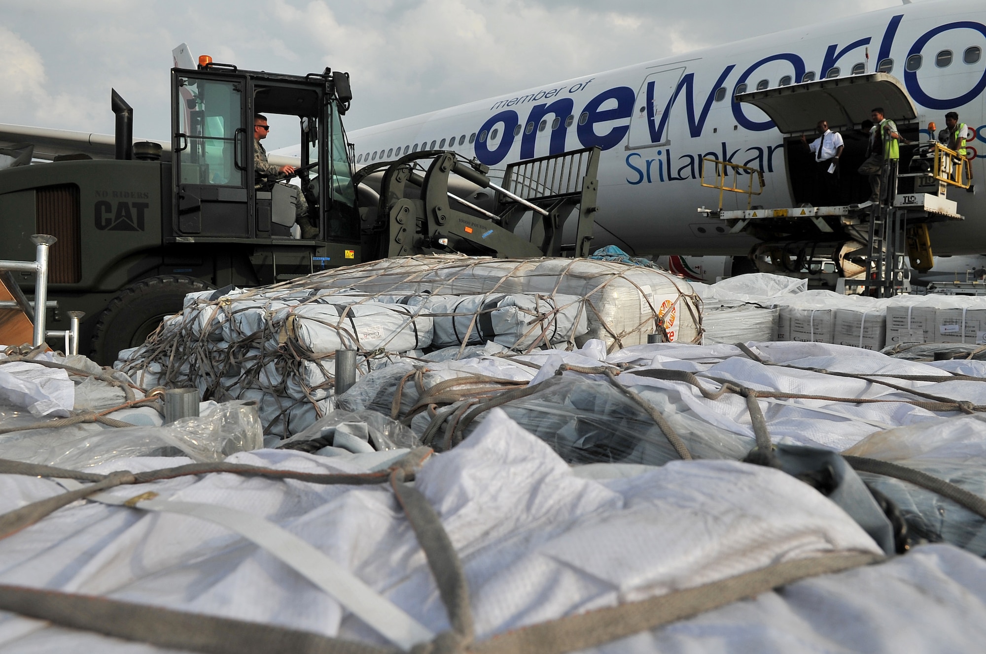 U.S. Air Force Tech. Sgt. Robert Koon, 36th Mobility Response Squadron noncommissioned officer in charge of command and control, moves relief supplies for a Sri Lanka cargo aircraft at the Tribhuvan International Airport in Kathmandu, Nepal, May 11, 2015. The Nepalese army and Airmen worked together to process 509,380 pounds of cargo in a 24-hour period from nine aircraft delivering relief supplies after a 7.8 magnitude earthquake struck the nation April 25, 2015. (U.S. Air Force photo by Staff Sgt. Melissa B. White/Released)