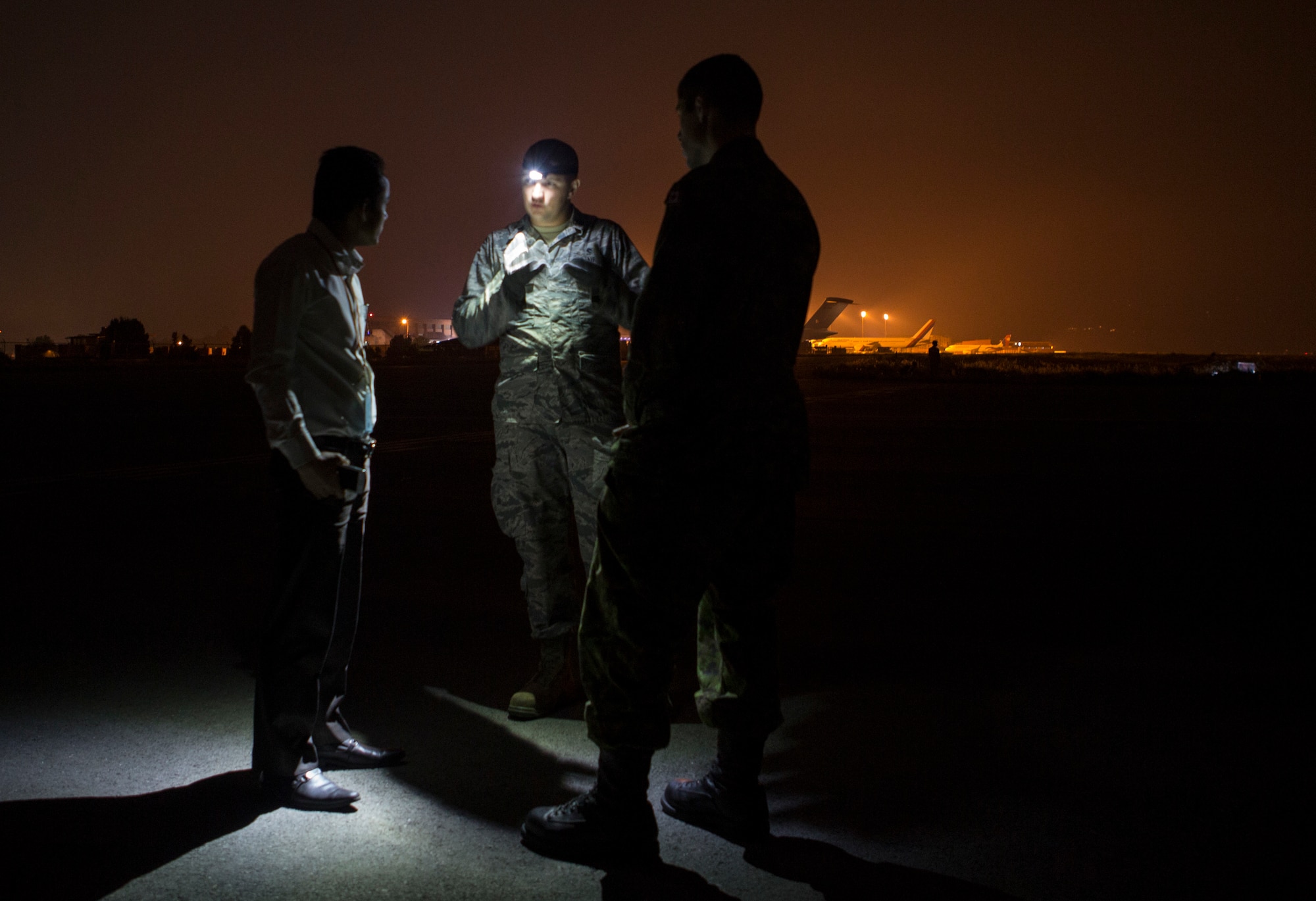 U.S. Air Force Capt. Clark Morgan, center, contingency engineer flight commander with the 36th Contingency Response Group, Joint Task Force-505 and Reno, Nevada native; Canadian Maj. Simon Comtois, right, a construction engineer with the Disaster Assistance Response Team; and Kumar Shresthna, a Nepalese civil engineer with the Civil Aviation Authority of Nepal discuss the process to determine the geotechnical engineering properties of the soil at the Tribhuvan International Airport, Kathmandu, Nepal, May 8, 2015. The team tested the soil using a dynamic cone penetrometer to determine its stability following the 7.8 magnitude earthquake.  The pavement evaluation tested to see if there were any significant changes to the soil beneath the runway since the earthquake. Any changes could restrict weight limitations to incoming flights in order to prevent any runway damage. The Nepalese government requested the U.S. Government assistance after a 7.8 magnitude earthquake struck the country April 25, 2015. JTF-505 is working in conjunction with USAID and the international community to assist Nepal. (U.S. Marine Corps photo by MCIPAC Combat Camera Staff Sgt. Jeffrey D. Anderson/Released)