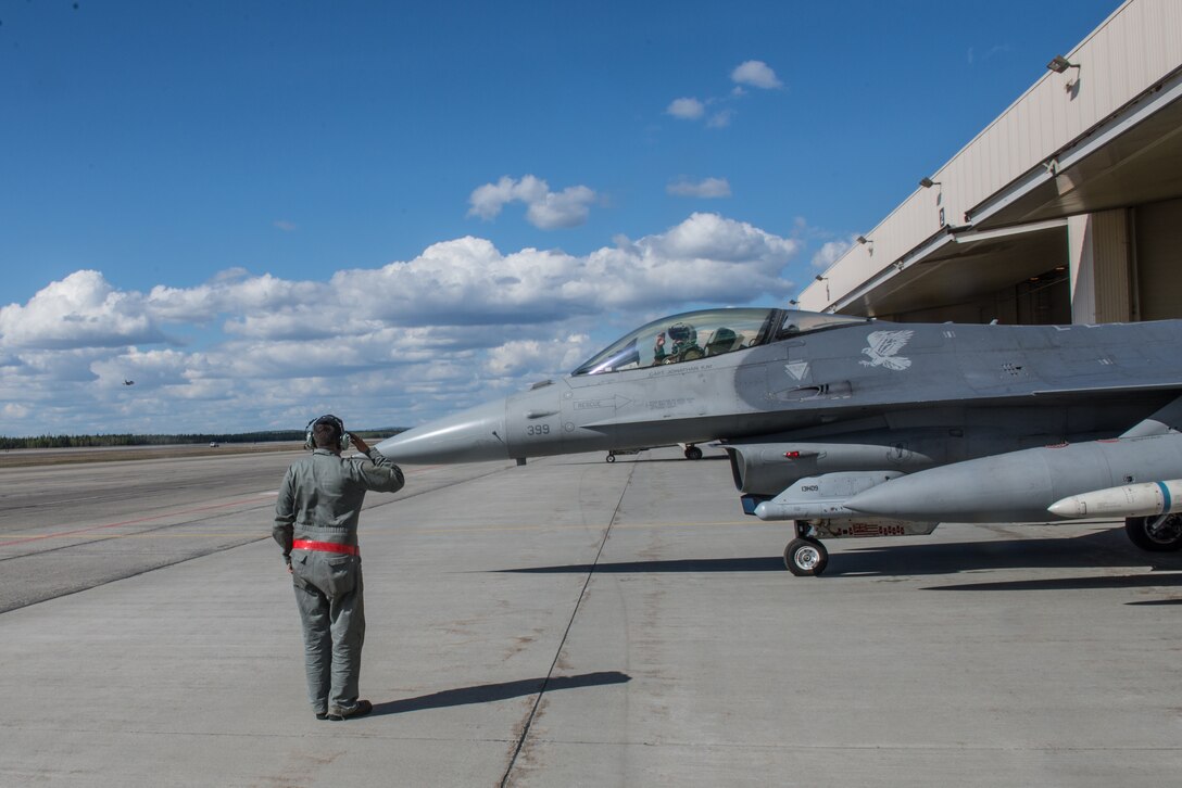 U.S. Air Force Staff Sgt. Cody Puente, a 13th Aircraft Maintenance Unit crew chief deployed from Misawa Air Base, Japan, launches a 13th Fighter Squadron F-16 Fighting Falcon on Eielson Air Force Base, Alaska, May 12, 2015, during RED FLAG-Alaska (RF-A) 15-2. RF-A is a series of Pacific Air Forces commander-directed field training exercises for U.S. and partner nation forces, providing combined offensive counter-air, interdiction, close air support and large force employment training in a simulated combat environment. (U.S. Air Force photo by Staff Sgt. Joshua Turner/Released)