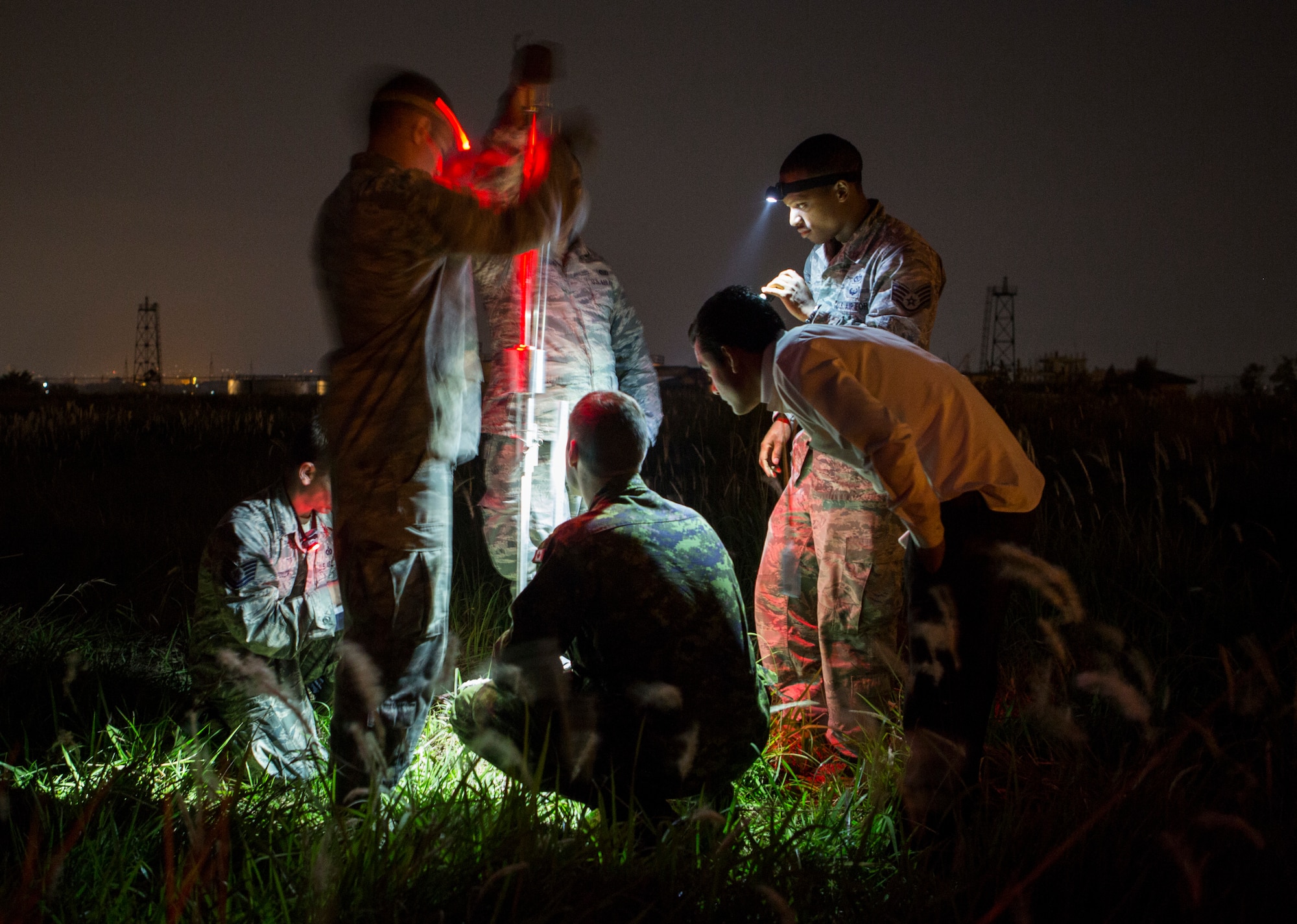 A multinational team comprised of U.S. Air Force engineers with the 36th Contingency Response Group, Joint Task Force-505, a member of the Disaster Assistance Response Team, and a Nepalese civil engineer with the Civil Aviation Authority of Nepal, determine the geotechnical engineering properties of the soil at the Tribhuvan International Airport,  Kathmandu, Nepal, May 8, 2015. The team tested the soil to determine its stability following the 7.8 magnitude earthquake that struck Nepal, April 25, 2015.  The pavement evaluation tested to see if there were any significant changes to the soil beneath the runway since the earthquake. Any changes could restrict weight limitations to incoming flights in order to prevent any runway damage. The Nepalese government requested the U.S. Government assistance after a 7.8 magnitude earthquake struck the country April 25, 2015. JTF-505 is working in conjunction with USAID and the international community to assist Nepal.JTF-505 works in conjunction with USAID and the international community to provide unique capabilities to assist Nepal. (U.S. Marine Corps photo by MCIPAC Combat Camera Staff Sgt. Jeffrey D. Anderson/Released)