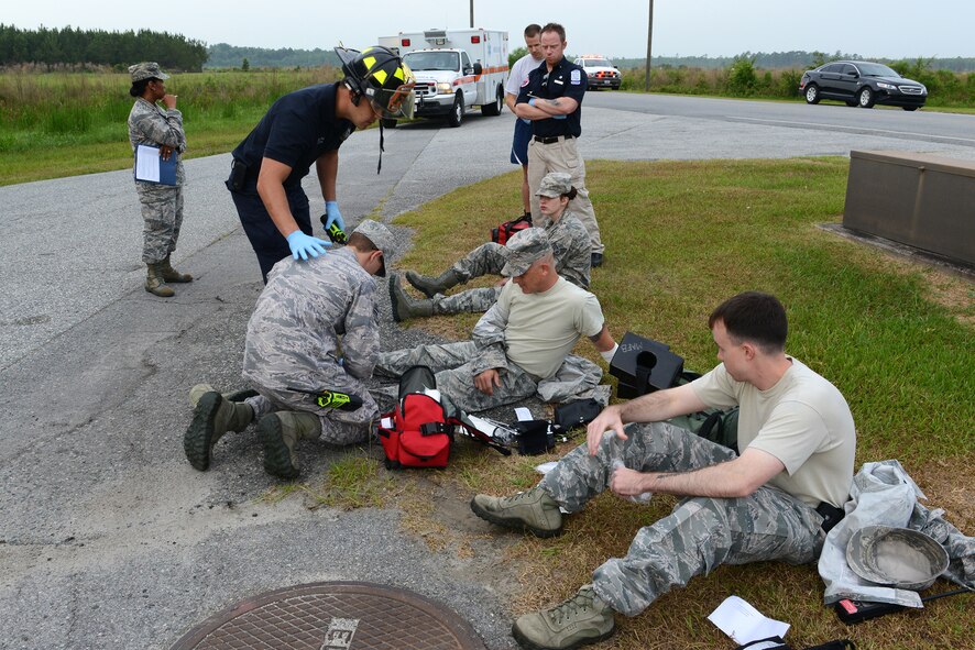 Moody first responders examine injured victims from falling debris in a collapsing building during the Hurricane Response exercise May 13, 2015, at Moody Air Force Base, Ga. The purpose of the exercise was to test the responses and find what needs to be improved in case of a real-world natural disaster. (U.S. Air Force photo by Airman 1st Class Kathleen D. Bryant/Released)



