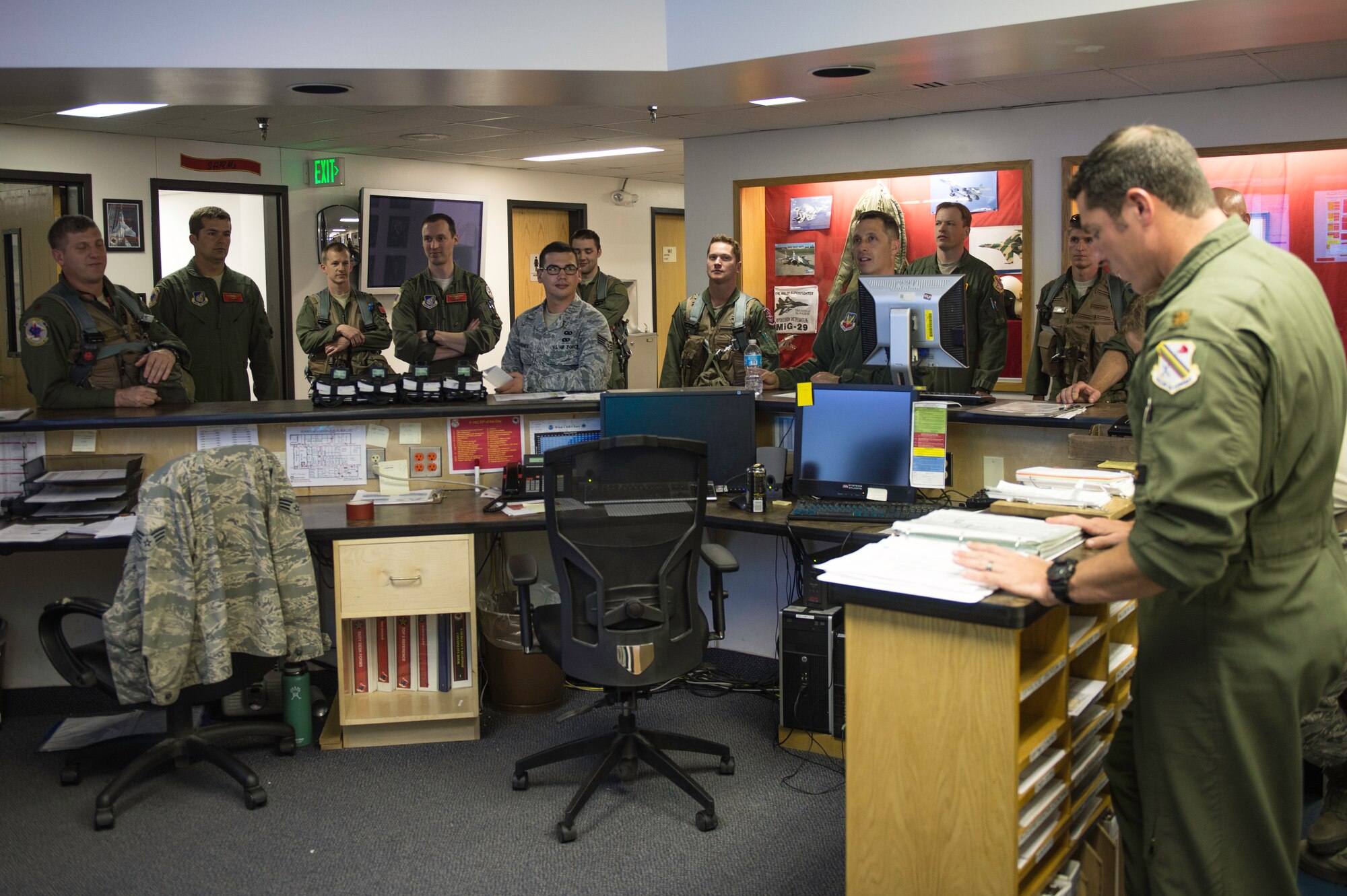 U.S. Air Force Staff Sgt. William Heines, an 18th Aggressor Squadron baron controller, stands as the only enlisted member during a pre-flight briefing for a Red Flag-Alaska (RF-A) 15-2 sortie May 12, 2015, at Eielson Air Force Base, Alaska. During RF-A, robust and accurate air war scenarios are enhanced by the barons who present ground threats and various types of jamming to provide problems blue forces will have to solve in order to gain and maintain air superiority. (U.S. Air Force photo by Staff Sgt. Shawn Nickel/Released)