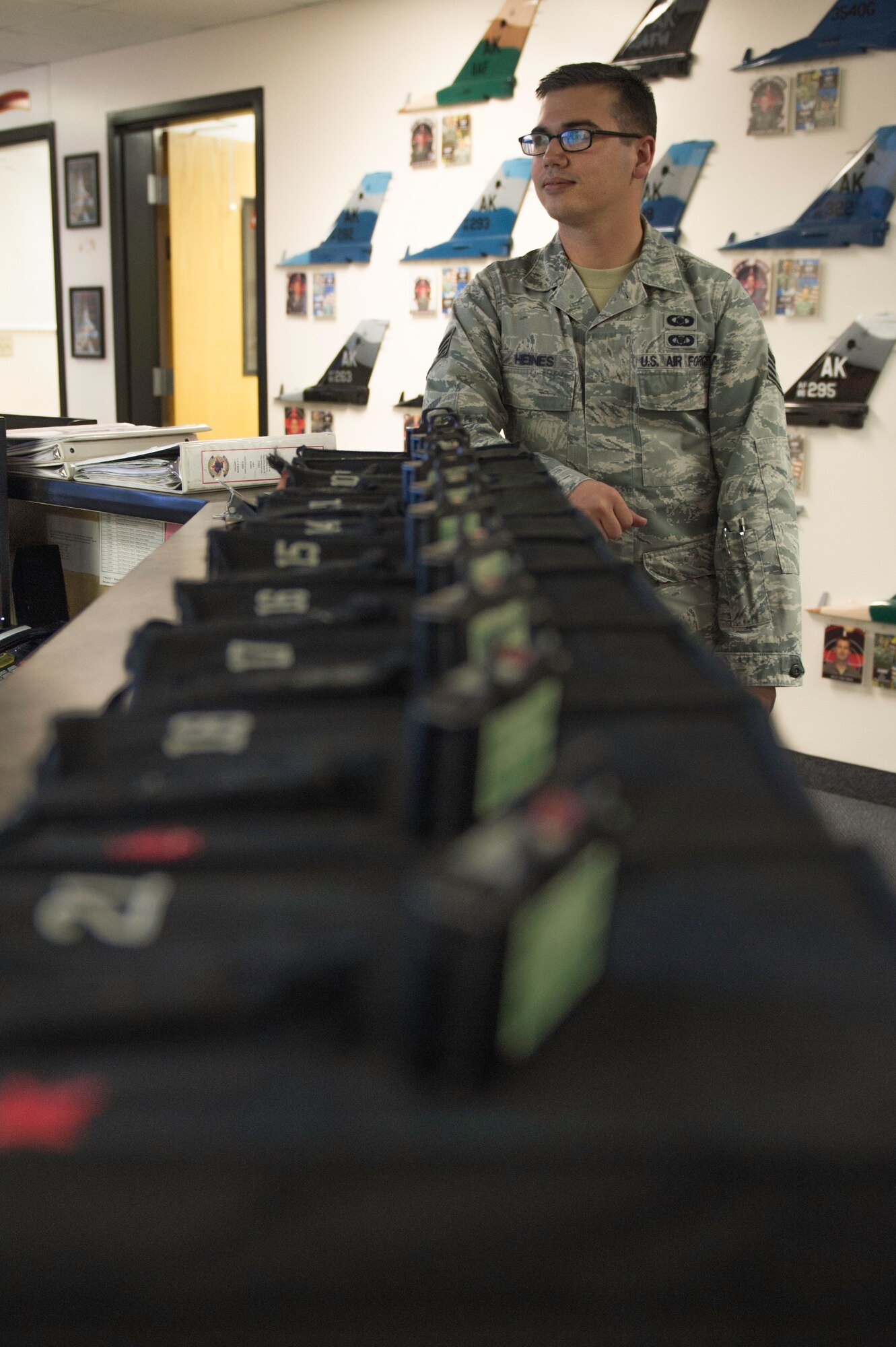 U.S. Air Force Staff Sgt. William Heines, an 18th Aggressor Squadron baron controller, checks the Red Flag-Alaska flight schedule at the squadron’s operation desk May 12, 2015, at Eielson Air Force Base, Alaska. Baron controllers earn their title as experts in enemy aerial battle tactics from around the world who teach others how combat these threats. (U.S. Air Force photo by Staff Sgt. Shawn Nickel/Released)
