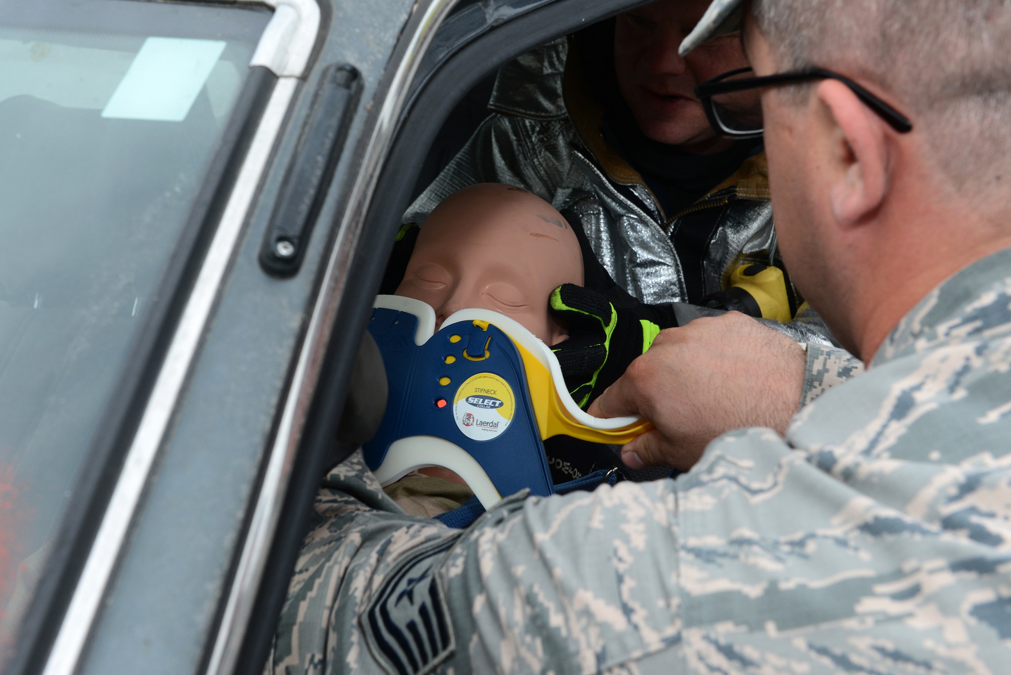 Moody first responders place a neck brace on a victim in a simulated car accident during the Hurricane Response exercise May 13, 2015, at Moody Air Force Base, Ga. The car accident scenario was a part of the aftermath of the fictional Hurricane Edgar. (U.S. Air Force photo by Airman 1st Class Kathleen D. Bryant/Released)
