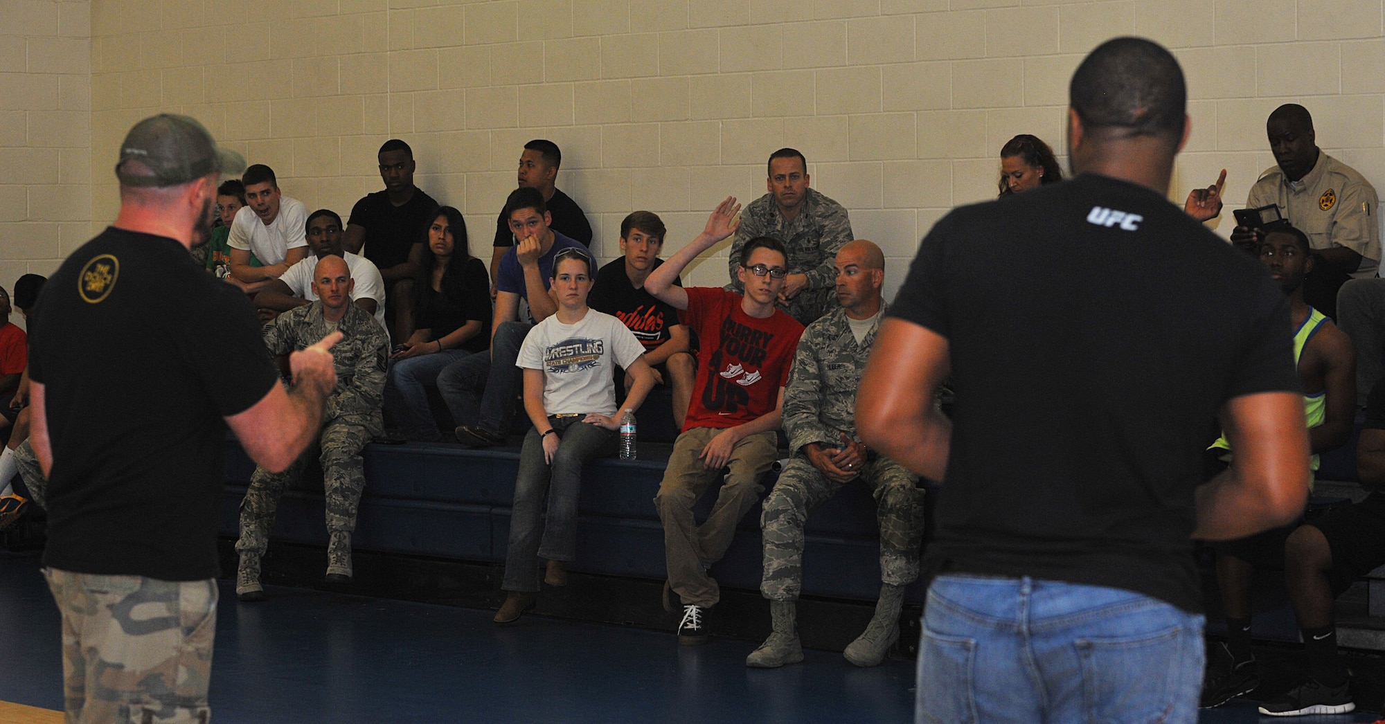 Former Ultimate Fighting Championship fighter Mike Dolce (left) and former UFC light-heavyweight champion Rashad Evans (right) take questions from audience members during an event at Barksdale Air Force Base, Louisiana, May 8, 2015. The two fighters came to Barksdale to discuss mental and physical health, nutrition and motivation with Airmen and their families. (U.S. Air Force photo/Senior Airman Joseph Raatz)