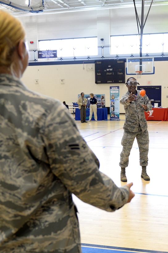 U.S. Air Force Senior Airman Marc Granville, 440th Supply Chain Operations Squadron security systems analyst, attempts to throw a ball while wearing “drunk goggles” during a volunteer fair at Langley Air Force Base, Va., May 8, 2015. Soldiers and Airmen Against Drunk Driving used the goggles during the event to stress the importance of always having a designated driver and to encourage participants to volunteer with the organization. (U.S. Air Force photo by Staff Sgt. Teresa J. Cleveland/Released)