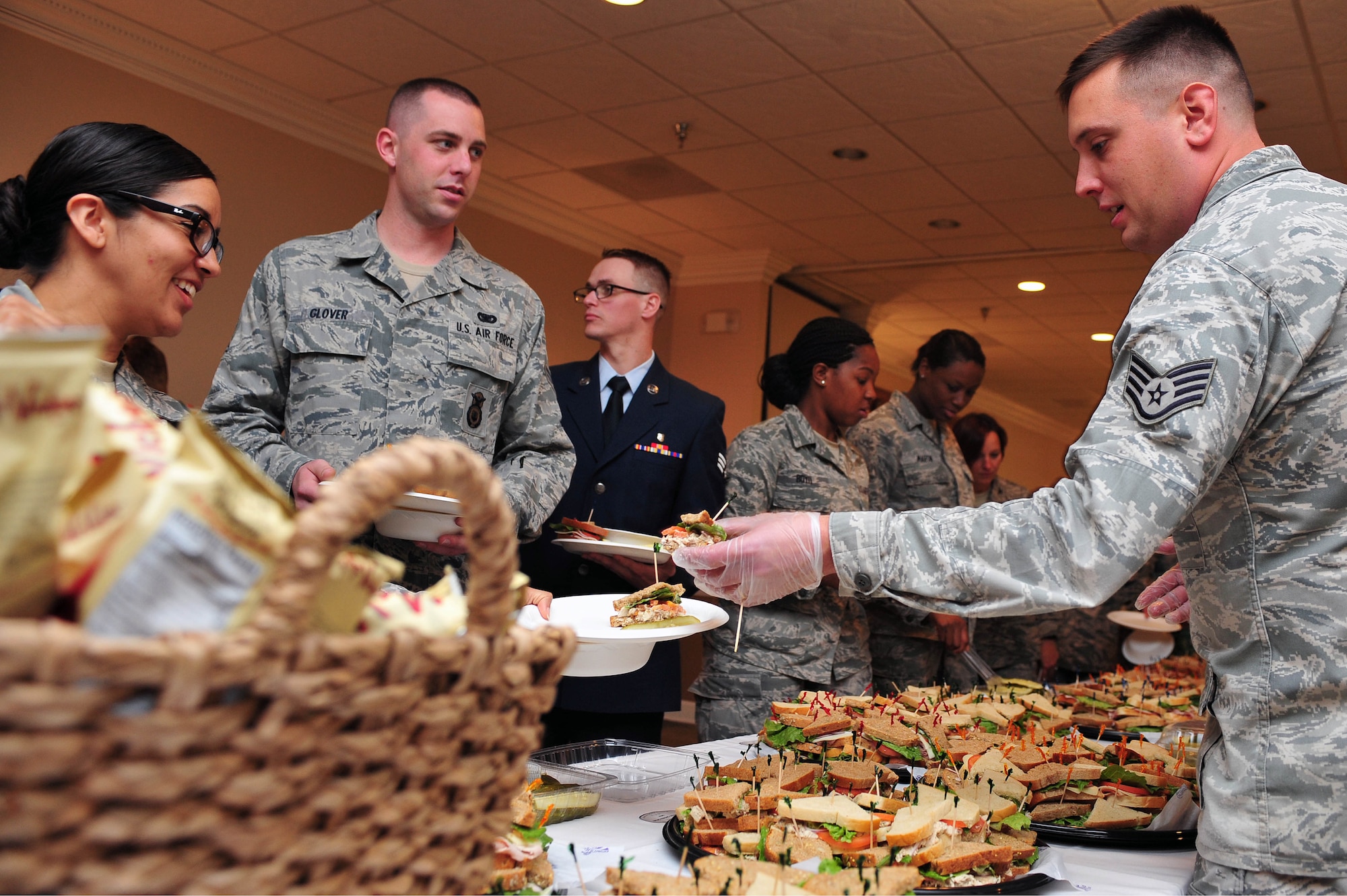 Staff Sgt. Matthew King (right), 4th Fighter Wing chaplain’s assistant, serves food to Airmen during the National Prayer Breakfast, May 7, 2015, at Seymour Johnson Air Force Base, North Carolina. The breakfast was an opportunity for Airmen around the base to gather together and share a meal while listening to guest speaker retired Army Staff Sgt. Shilo Harris. (U.S. Air Force photo/Senior Airman John Nieves Camacho)