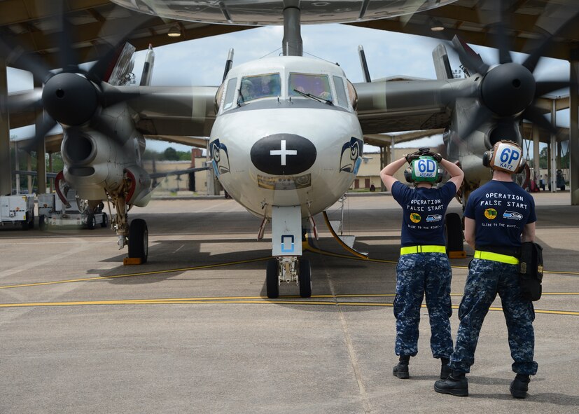 Aviation Machinist Mate 1st Class Caitlin Addams, assigned to the Seahawks of Carrier Airborne Early Warning Squadron, VAW-126, Norfolk, Virginia, performs a full systems preflight check on an E-2C Hawkeye prior to departure at Barksdale Air Force Base, Louisiana, April 22, 2015. Addams assists the pilot in flight preparation and advises the pilot of the material condition of the aircraft. (U.S. Air Force photo/Senior Airman Joseph A. Pagán Jr.)