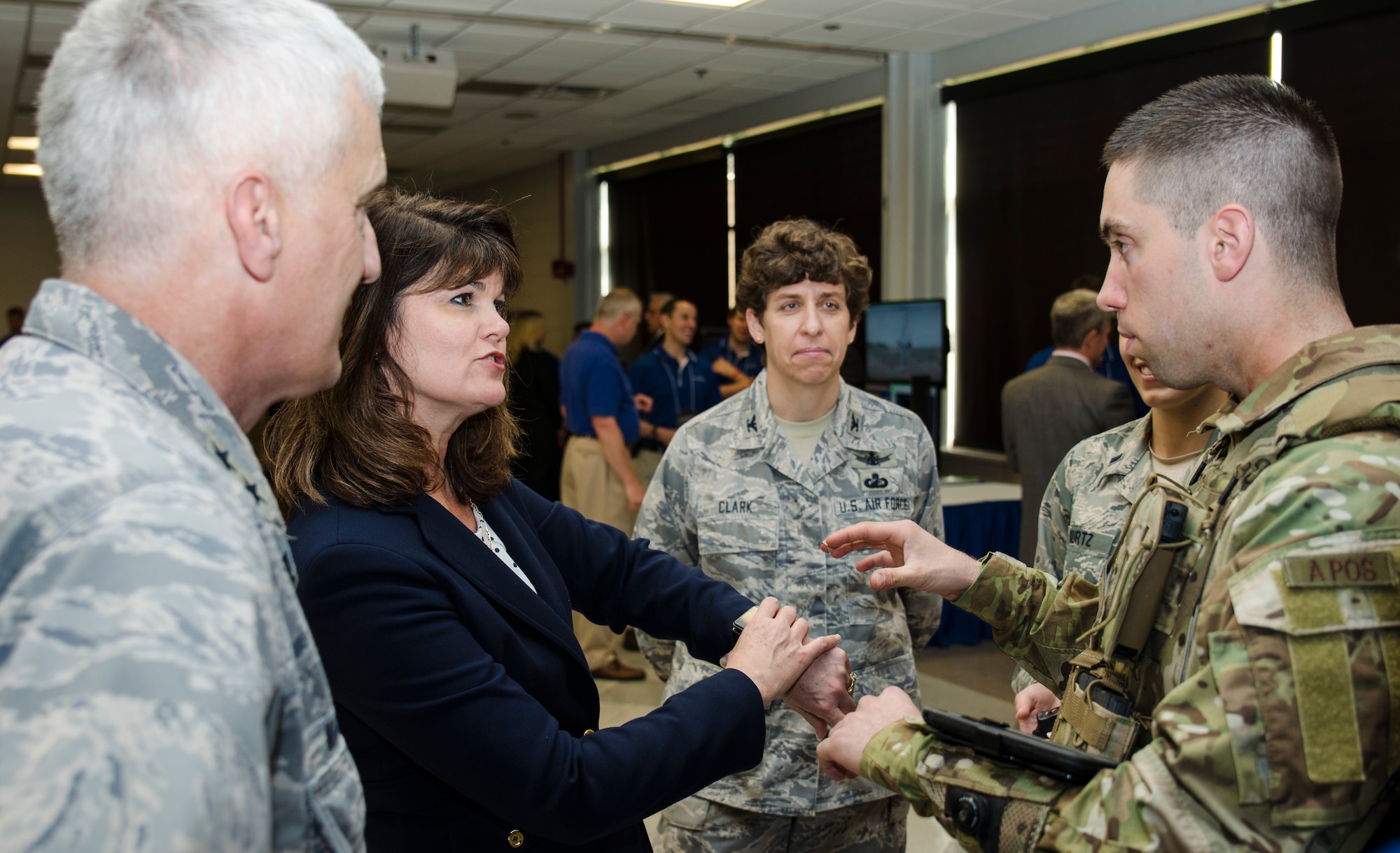 2nd Lt. Tony Eastin, behavioral scientist at Air Force Research Laboratory's 711th Human Performance Wing, and Dr. Mica Endsley discuss integrating consumer physiological sensors with AFRL's BATMAN suite of warfighting Airmen worn technologies. Dr, Endsley, the Air Force's chief scientist, joined AFRL commander, Maj. Gen. Tom Masiello, during a May review of technologies to be featured during the DoD Lab Day event May 14 at the Pentagon. (U.S. Air Force photo by Mikee Huber)
