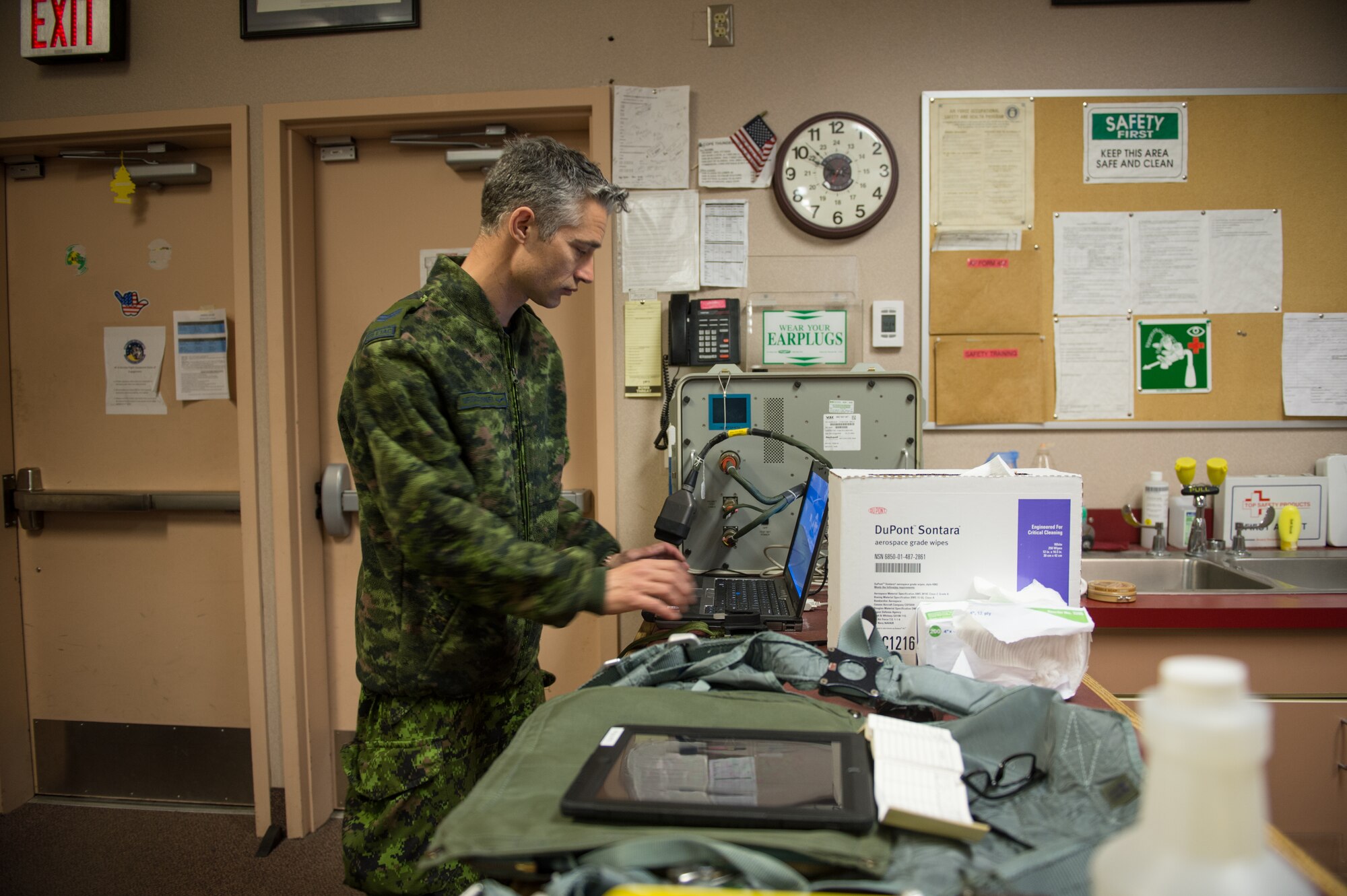 Royal Canadian air force Cpl. Yannick Deschesnes, an aircrew flight equipment technician from the 425th Tactical Fighter Squadron, tests a joint helmet-mounted cueing system for a CF-18 Hornet pilot at Eielson Air Force Base, Alaska, May 7, 2015, during RED FLAG-Alaska (RF-A) 15-2. After testing and certifying aircrew flight equipment, Deschesnes will transition to the role of crew chief and launch jets during RF-A to reduce the amount of manning required while on temporary duty. (U.S. Air Force photo by Staff Sgt. Shawn Nickel/Released)