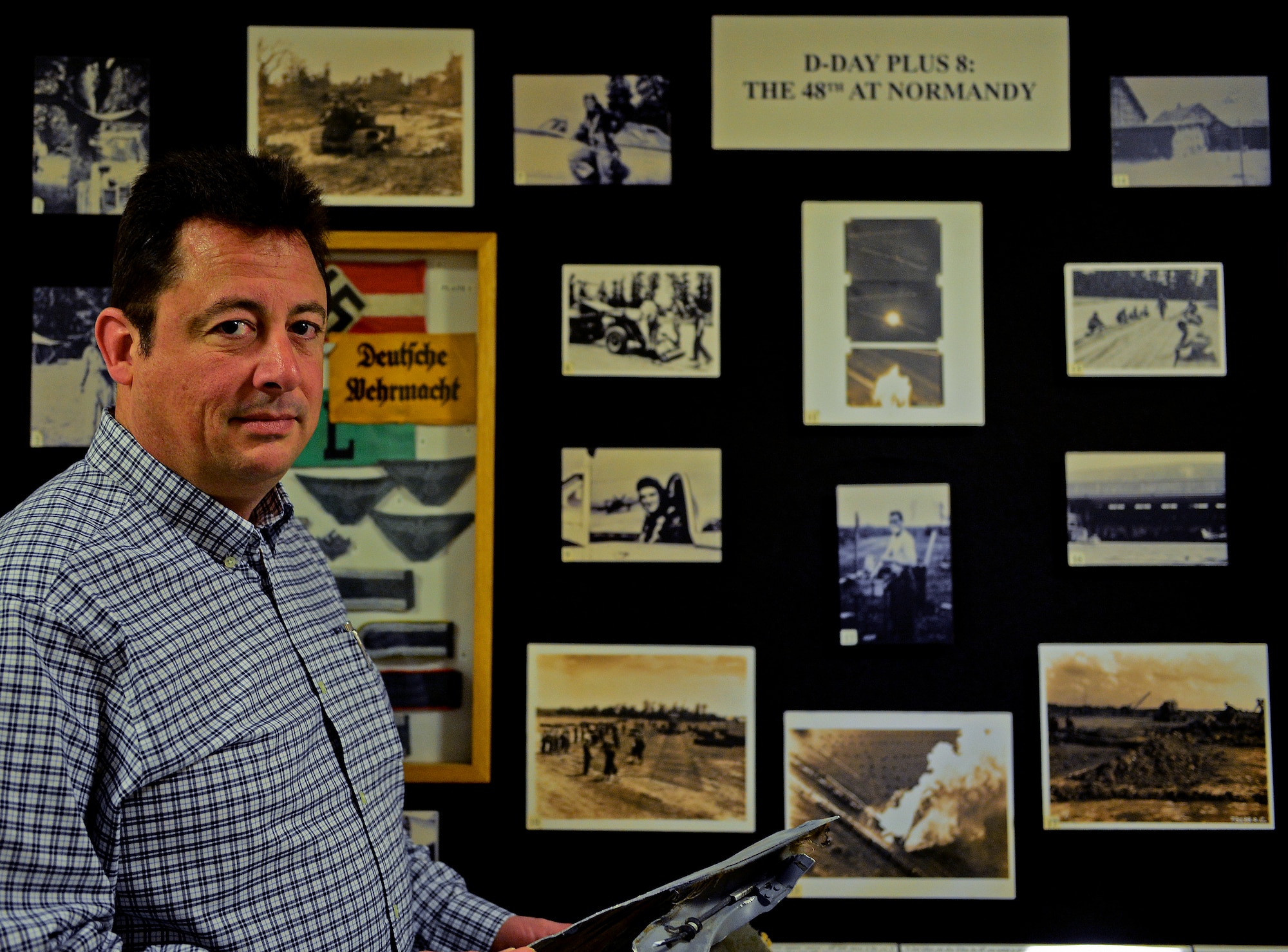 Peter Law, 48th Fighter Wing historian, stands in front of a historical display in the wing headquarters building May 8, 2015. Law recently received the Allan S. Major Award for best history program and the Dennis F. Casey Award for excellence in periodic history. These Air Force-level awards recognize historians who provided superior historical services to their unit and submitted an excellent periodic history during the past year. (U.S. Air Force photo by Airman 1st Class Dawn M. Weber/Released)