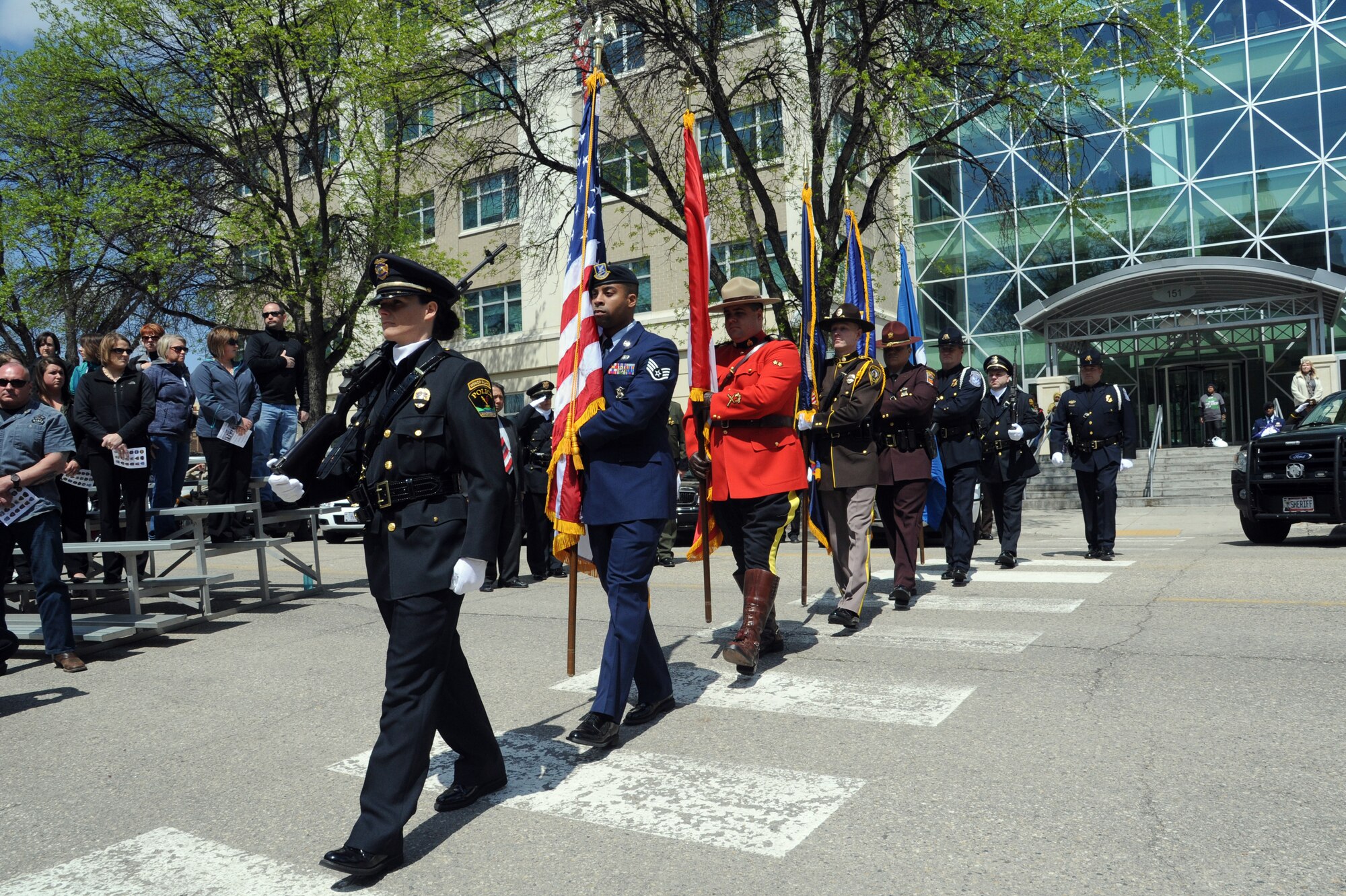 A color guard representing police forces from the United States and Canada march during the annual Police Week memorial ceremony in Grand Forks, N.D., May 12, 2015. The ceremony paid tribute to law enforcement officers who have lost their lives in the line of duty. (U.S. Air Force photo by Staff Sgt. David Dobrydney/released)