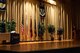 The stage awaiting the arrival of the official party to begin the Community College of the Air Force graduation ceremony at the base theater on Goodfellow Air Force Base, Texas, May 8, 2015. The ceremony also included the Pitsenbarger awards and Powell Warrior award. (U.S. Air Force photo by Senior Airman Scott Jackson)