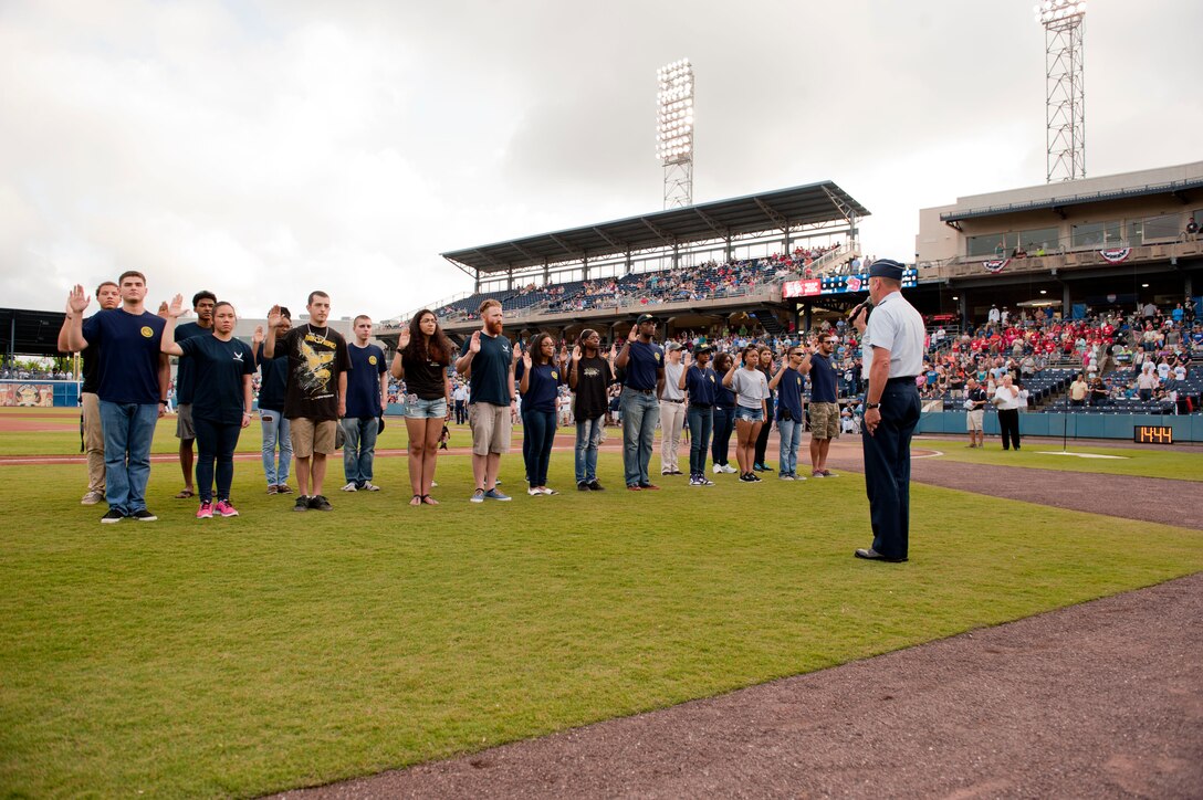 U.S. Air Force Brig. Gen. Jon Thomas, Joint Staff deputy director, reads the oath of enlistment to Delayed Entry Program participants during the Norfolk Tides Armed Forces Appreciation night in Norfolk, Va., May 9, 2015. The event, held every May, is held during Military Appreciation Month. (U.S. Air Force photo by Staff Sgt. Stephanie Rubi/Released)