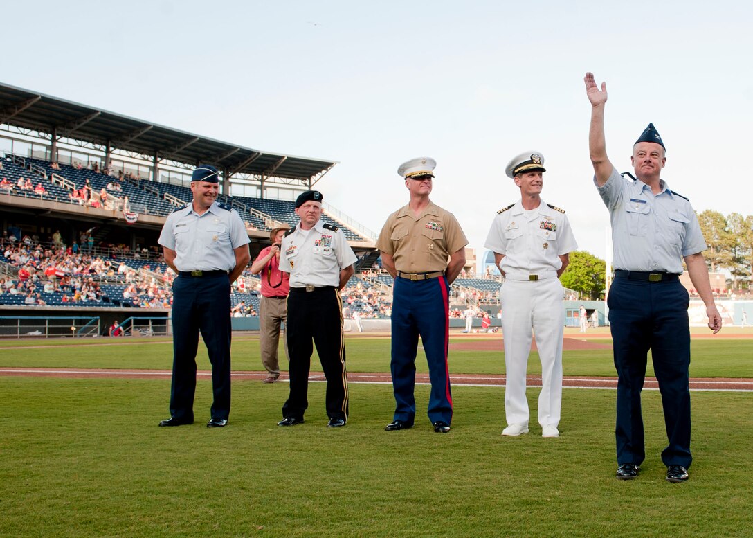 U.S. Air Force Col. James Forrest, 633rd Medical Group deputy commander, waves to the crowd during the Norfolk Tides Armed Forces Appreciation night in Norfolk, Va., May 9, 2015. Forrest was recognized as the Air Force representative from Joint Base Langley-Eustis. The event included a presentation of the colors by the U.S. Joint Service Color Guard and first pitches by Service members from each branch of the Armed Forces. (U.S. Air Force photo by Staff Sgt. Stephanie Rubi/Released)