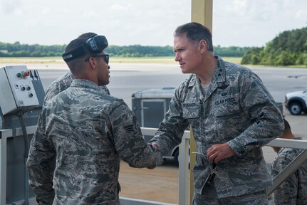 Maj. Gen. Kurt F. Neubauer speaks with Senior Airman Chris O'Grady, 437th Aerial Port Squadron ramp specialist, May 6, 2015, at Joint Base Charleston, S.C. Neubauer is the Air Force Chief of Safety, Headquarters U.S. Air Force, Washington, D.C., and Commander, Air Force Safety Center, Kirtland Air Force Base, N.M. He develops, executes and evaluates all Air Force aviation, ground, weapons, space and system mishap prevention, and nuclear surety programs to preserve combat readiness. In addition to touring Joint Base Charleston, Neubauer was the guest speaker at the Charleston Metro Chamber of Commerce's State of the Region: Salute to the Military event May 7, 2015 on the USS Yorktown at Patriot’s Point in Mount Pleasant, S.C. (U.S. Air Force photo/Senior Airman George Goslin)