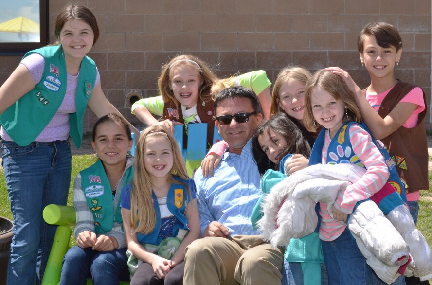 Natalie Moore (seated, left), a fourth grade student at Ellicott Elementary School and Schriever resident, sits on one of the Buddy Benches she donated to the school May 11, 2015, at Ellicott, Colo., with Ellicott Elementary Principal Joe Torrez and members of her Girl Scout troop. Moore created the benches as her project to promote positive, lasting change to her community and earn her Girl Scout Bronze Award. (U.S. Air Force photo/Brian Hagberg)