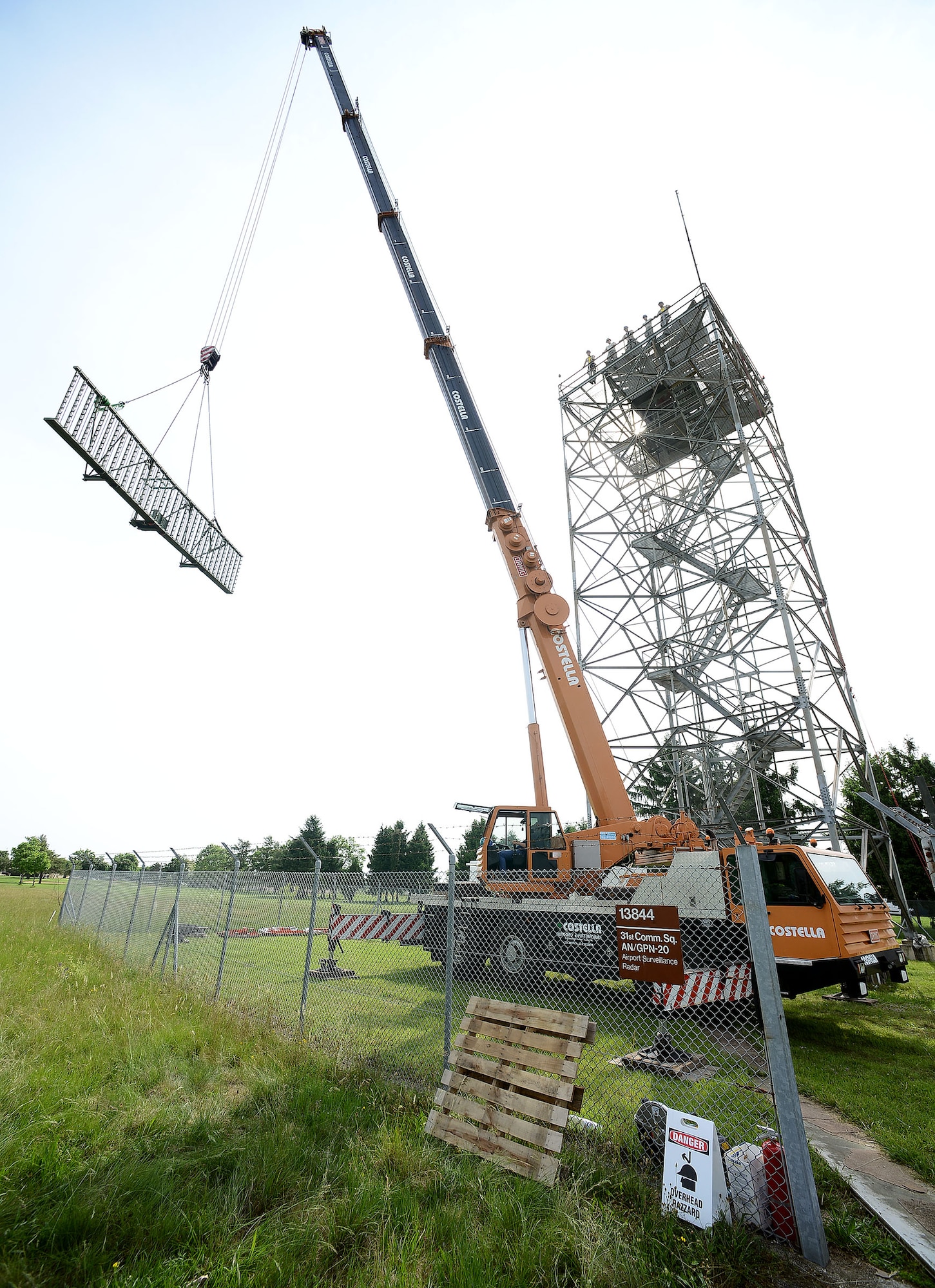 A crane removes a portion of a Ground Pulse Navigation-20 Airport Surveillance Radar antenna, May 13, 2015, at Aviano Air Base, Italy. Airmen assigned to the Headquarters Air Force Flight Standards Agency-European Regional Maintenance Center from Kapaun Air Station, Germany, teamed with the 31st Operations Support Squadron ground radar maintenance flight and the Air Force Life Cycle Management Center from Hanscom Air Force Base, Mass., to remove the decommissioned antenna from a 77-foot tower. (U.S. Air Force photo by Staff Sgt. R.J. Biermann/Released)