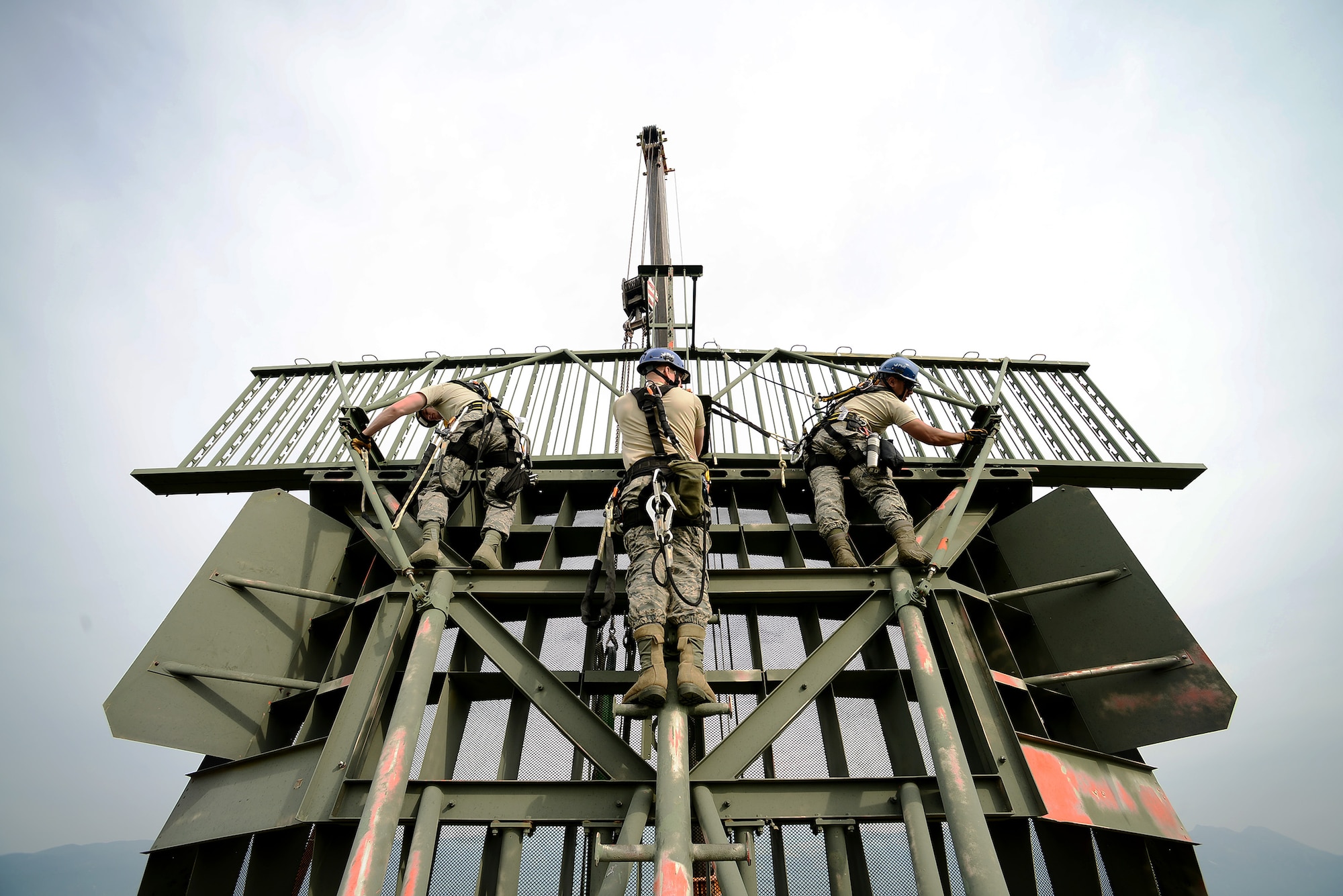 A team of radar systems technicians assigned to the Headquarters Air Force Flight Standards Agency-European Regional Maintenance Center from Kapaun Air Station, Germany, prepare to remove a Ground Pulse Navigation-20 Airport Surveillance Radar antenna, May 13, 2015, at Aviano Air Base, Italy. The team worked with the 31st Operations Support Squadron ground radar maintenance flight and the Air Force Life Cycle Management Center from Hanscom Air Force Base, Mass., to remove the decommissioned antenna from a 77-foot tower. (U.S. Air Force photo by Staff Sgt. R.J. Biermann/Released)