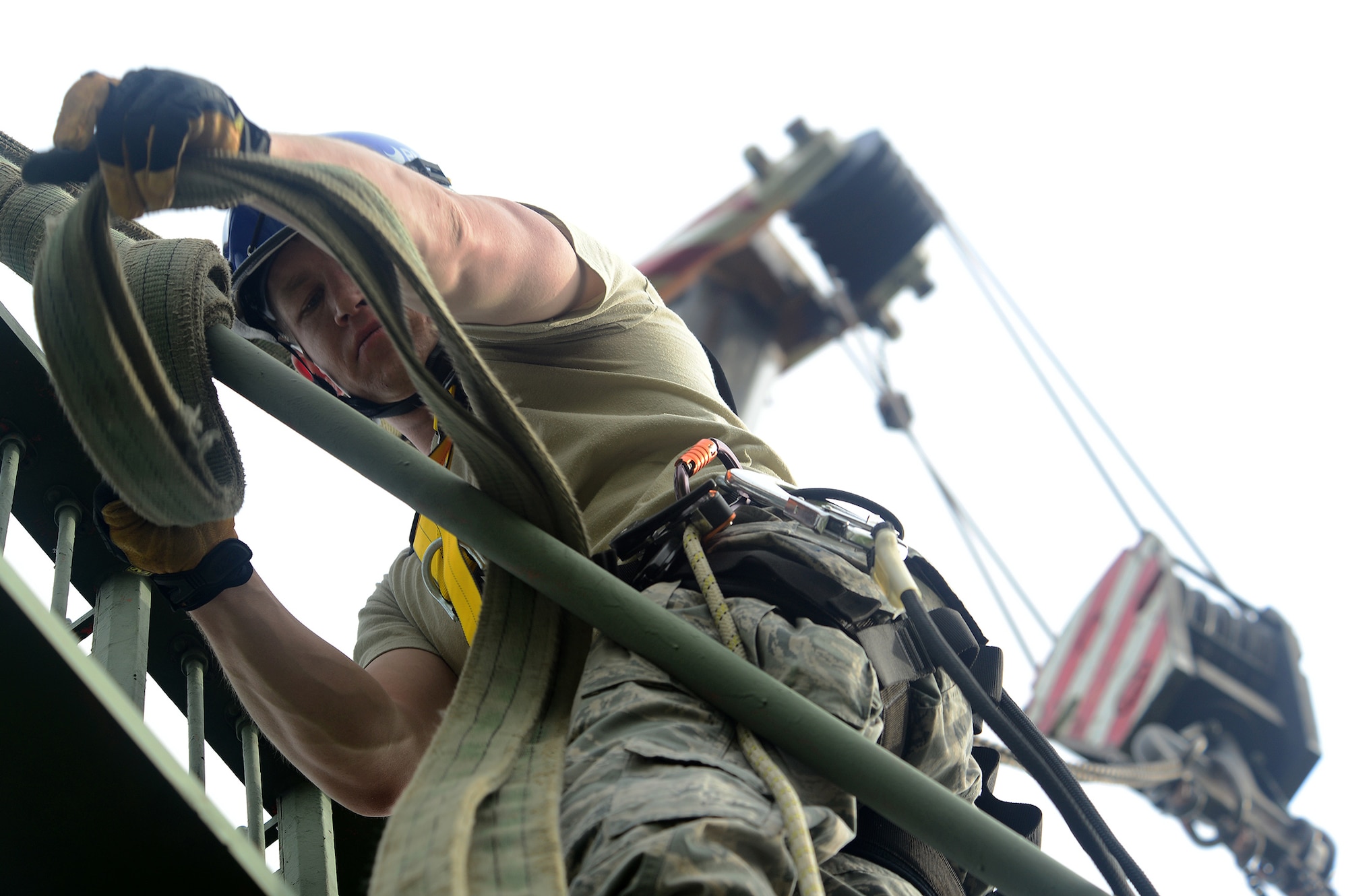 U.S. Air Force Tech. Sgt. Joseph McKeown, Headquarters Air Force Flight Standards Agency-European Regional Maintenance Center radar systems team lead, attaches a crane sling to a Ground Pulse Navigation-20 Airport Surveillance Radar antenna, May 13, 2015, at Aviano Air Base, Italy. The team of radar systems technicians from Kapaun Air Station, Germany, worked with the 31st Operations Support Squadron ground radar maintenance flight and the Air Force Life Cycle Management Center from Hanscom Air Force Base, Mass., to remove the decommissioned antenna from a 77-foot tower. (U.S. Air Force photo by Staff Sgt. R.J. Biermann/Released)