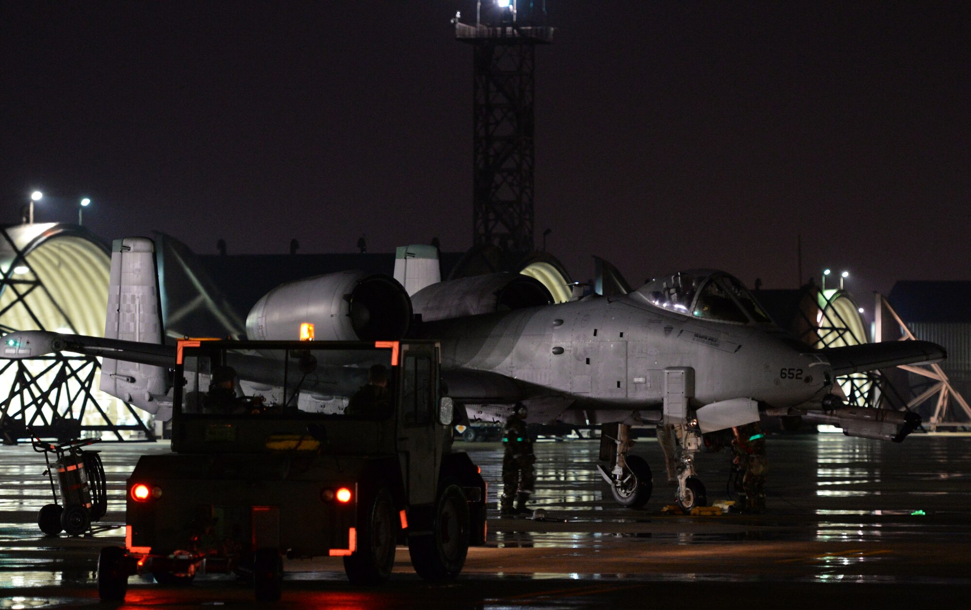 Members of Team Osan prepare an A-10 Thunderbolt II for take-off May 12, 2015, at Osan Air Base, Republic of Korea. The Airmen are working 12-hour shifts both day and night while participating in the combat exercise Beverly Midnight 15-02. Despite the rain, unseasonably colder temperatures and exercise injects, maintainers from Team Osan successfully prepped and recovered aircraft throughout the night. (U.S. Air Force photo by Staff Sgt. Benjamin Sutton/Released)