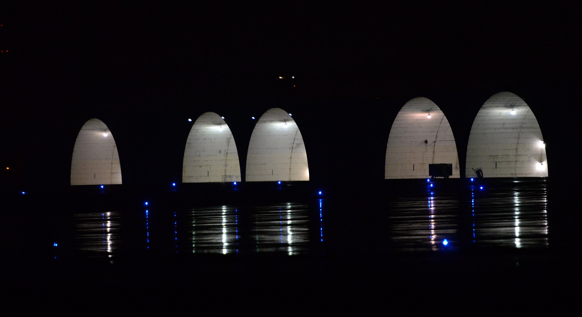 The hardened facilities for aircraft to run engines and even hot pit refuel are lit up May 12, 2015, at Osan Air Base, Korea. Team Osan is participating in the combat exercise Beverly Midnight 15-02 and aircraft are constantly using the flow facilities 24-hours a day. These facilities assist member of Team Osan with guarding the freedom of 51 million people across the peninsula. (U.S. Air Force photo by Staff Sgt. Benjamin Sutton/Released) 