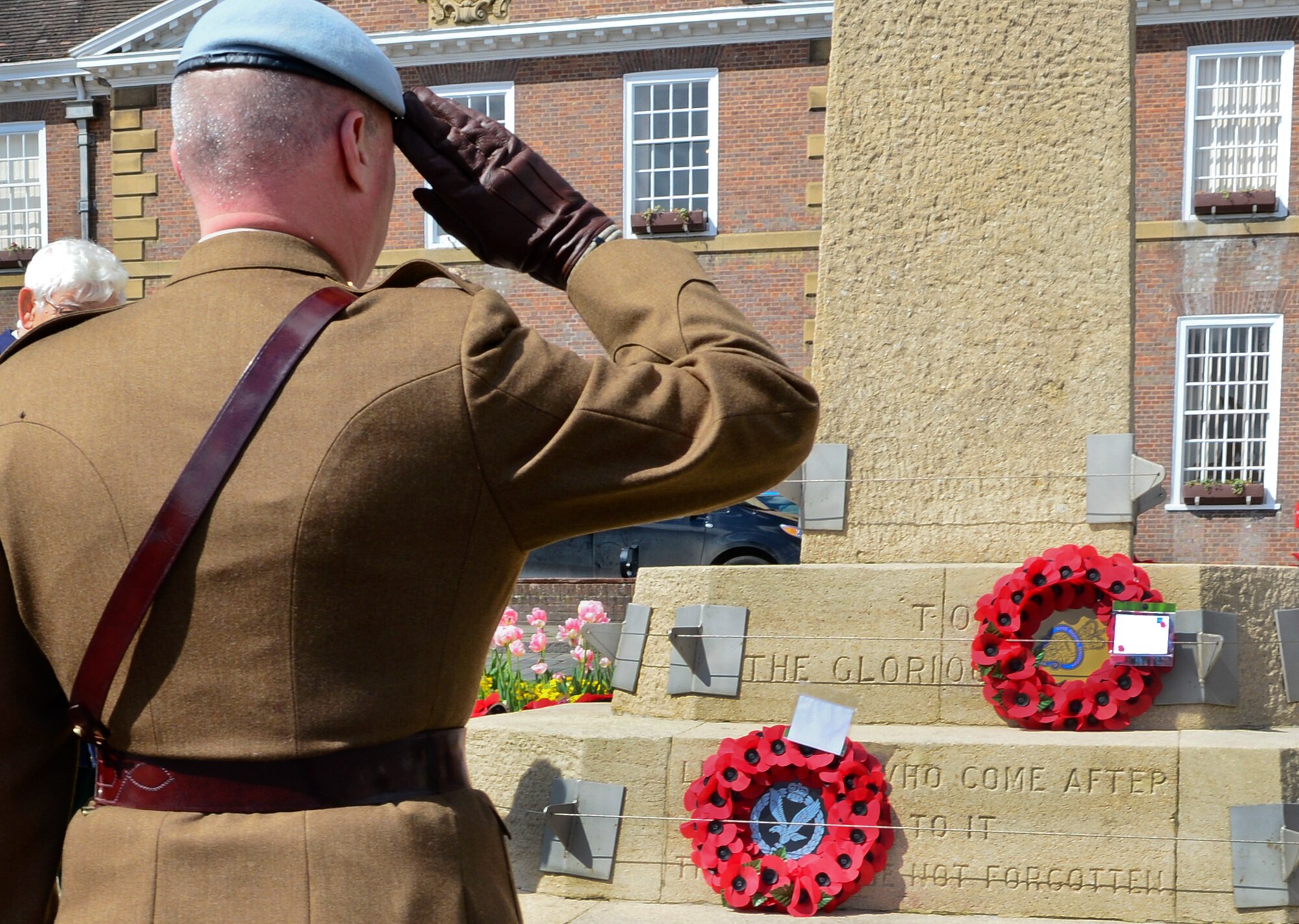 A salute is rendered by a former British solider at a World War II memorial in Bury St. Edmunds, England, May 9, 2015. May 8th marked the 70th Anniversary of the end of World War II, which ended the Nazi rule in Europe. (U.S. Air Force photo by Airman 1st Class Dawn M. Weber/Released)