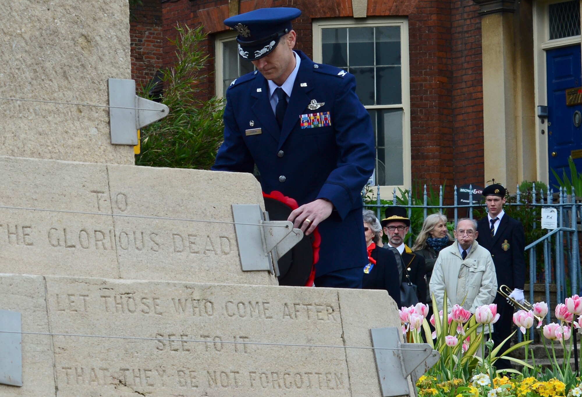 Col. Scottie Zamzow, 48th Operations Group commander, lays a wreath on a War World II memorial in Bury St. Edmunds, England, May 9, 2015. Poppies are a significant memorial symbol to the men and women who bravely served and lost their lives in war. (U.S. Air Force photo by Airman 1st Class Dawn M. Weber/Released)