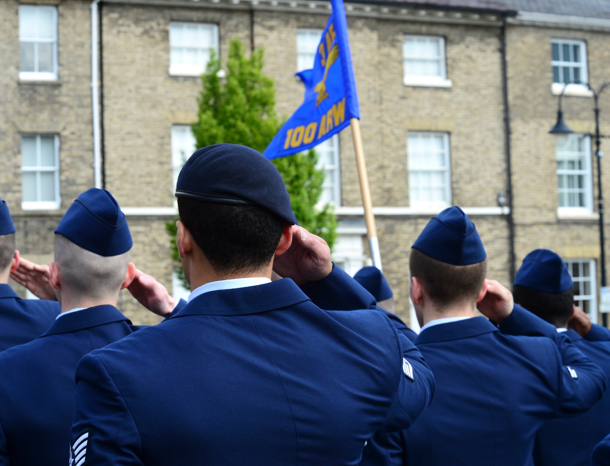 Airmen from Royal Air Force Mildenhall render a salute during the playing of the National Anthem during a Victory in Europe Day memorial service in Bury St. Edmunds, England, May 9, 2015. May 8th marked the 70th Anniversary of the end of World War II, which ended the Nazi rule in Europe. (U.S. Air Force photo by Airman 1st Class Dawn M. Weber/Released)