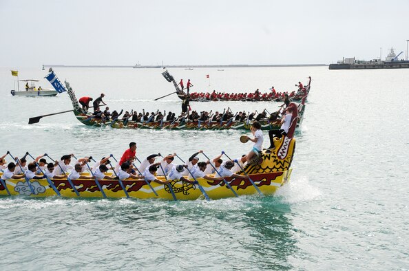 The Kadena Shoguns men’s team (back) races neck-and-neck with two other teams in their heat during the Naha Dragon Boat races at Naha Port, Japan, May 5, 2015. The Kadena Shoguns men’s team placed ninth out of the 63 teams that competed that day. (U.S. Air Force photo by Senior Airman Omari Bernard)
