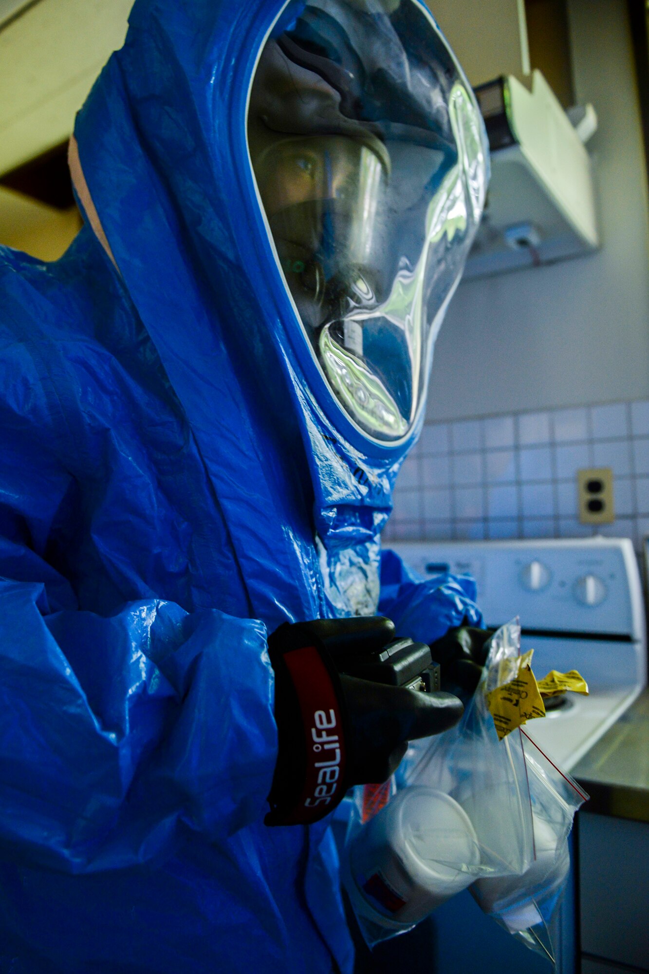 Senior Airman Vonfernan Carios, 374th Aerospace Medicine Squadron bioenvironmental engineering technician, carries samples taken from the scene of a mock environmental hazard, May 6, 2015, at Yokota Air Base, Japan. Airmen from the 374th Civil Engineering Squadron and the 374 AMDS worked together to respond during an emergency response training exercise. (U.S. Air Force photo by Airman 1st Class Elizabeth Baker/Released)