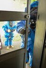Maj. Edgar Cadua, 374th Aerospace Medicine Squadron bioenvironmental flight commander, uses infrared spectroscopy to screen for hazards during an emergency response training exercise, May 6, 2015, at Yokota Air Base, Japan. He wears a chemical suit designed to protect him from chemical, biological and radiological hazards. (U.S. Air Force photo by Airman 1st Class Elizabeth Baker/Released)