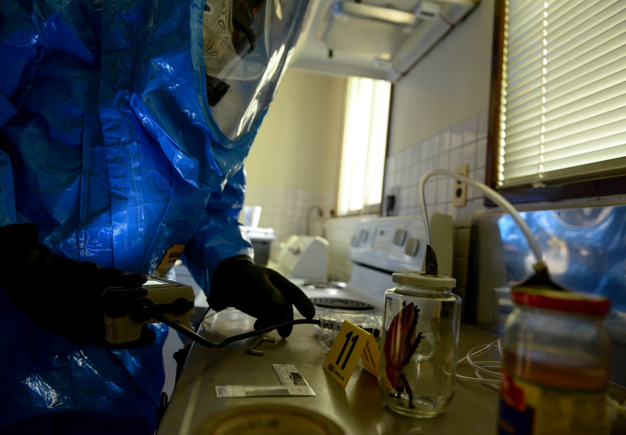 Senior Airman Carlos Tovar, 374th Civil Engineer Squadron emergency management journeyman, uses a spectroscopy instrument to identify unknown solid and liquid samples, May 6, 2015, at Yokota Air Base, Japan.  The instrument, which is utilized by first responders, homeland security, military, law enforcement and forensic chemistry personnel, uses a laser to identify samples. (U.S. Air Force photo by Airman 1st Class Elizabeth Baker/Released)