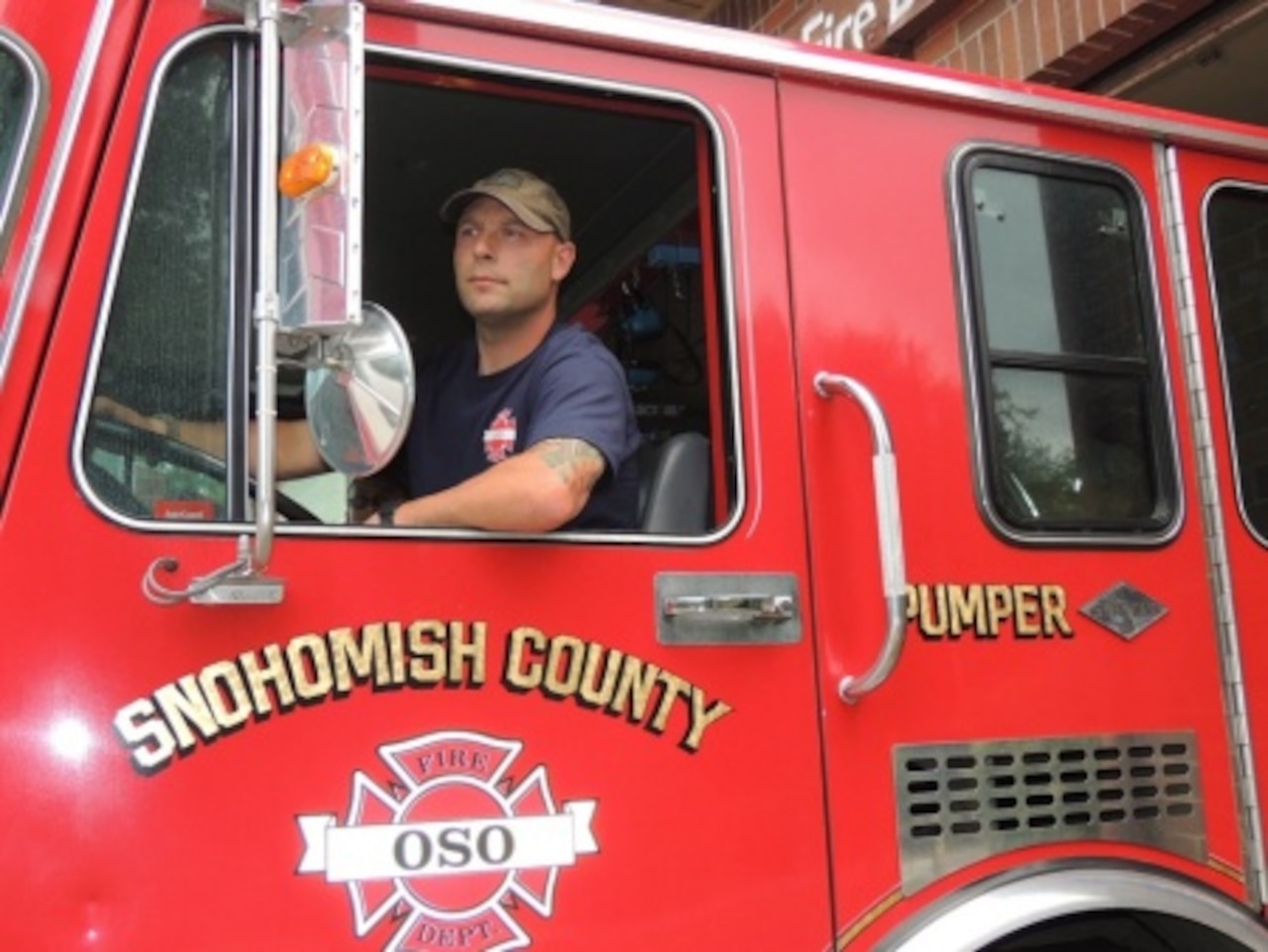 U.S. Coast Guard reservist Petty Officer 1st Class Ryan Olson steers an Oso Fire Department vehicle out of the station in Oso, Wash., Aug. 11, 2012. Olson is a maritime enforcement specialist with Port Security Unit 313 in Everett, Wash., and the Coast Guard's 2014 Enlisted Person of the Year -- Reserve Component. Courtesy photo