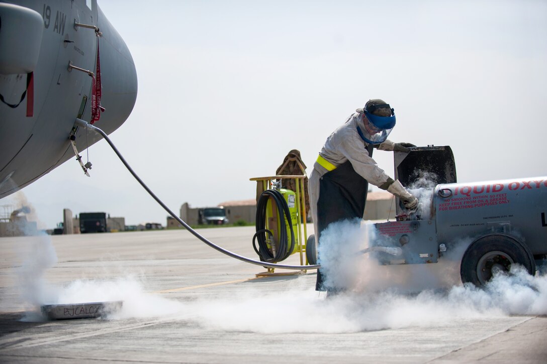 U.S. Air Force Airman 1st Class Ryan Munchel transfers liquid oxygen to an LOX reservoir in a C-130J Super Hercules aircraft on the flightline at Bagram Airfield, Afghanistan, May 5, 2015. Munchel is assigned to the 455th Expeditionary Aircraft Maintenance Squadron.