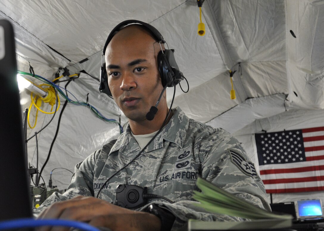 U.S. Air Force Staff Sgt. Dan Dixon coordinates with transiting aircraft to receive ground support in Kathmandu, Nepal, May 11, 2015. Dixon is a mobile command and control controller assigned to the 36th Contingency Response Group.
