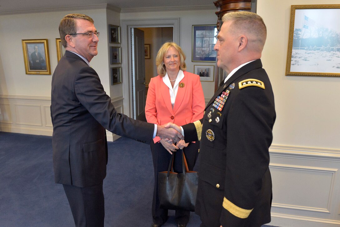 Defense Secretary Ash Carter greets Army Gen. Mark A. Milley, and his wife, Hollyanne, in his office before a briefing at the Pentagon, May 13, 2015, where he announced Milley as the choice for the next Army chief of staff.