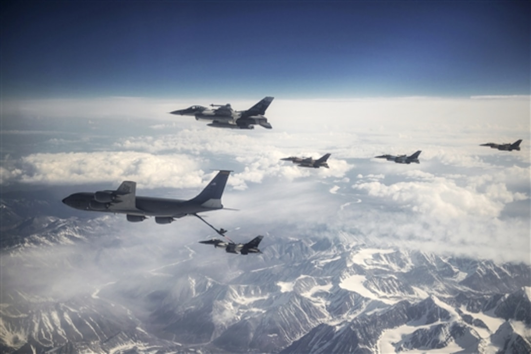 Air Force F-16 Fighting Falcons refuel behind a KC-135 Stratotanker during Red Flag-Alaska 15-2 while flying over the Joint Pacific Alaska Range Complex, May 11, 2015. The exercise allows participating units to exchange tactics, techniques and procedures as well as improve interoperability. The F-16 is assigned to the 18th Aggressor Squadron on Eielson Air Force Base, Alaska. The Stratotanker is assigned to the Pennsylvania Air National Guard’s 171st Air Refueling Wing.