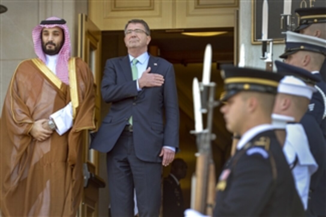 U.S.Defense Secretary Ash Carter places his hand over his heart as the national anthem plays during an honor cordon to welcome Saudi Defense Minister Mohammed bin Salman Al Saud to the Pentagon, May 13, 2015. The two defense leaders met to discuss matters of mutual interest.