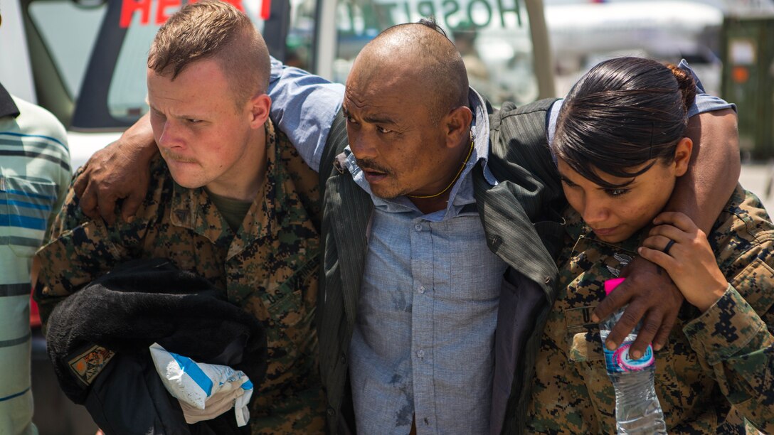 U.S. Marine Corps Lance Cpl. John Kingwell and U.S. Navy Hospital Corpsman 2nd Class Jessica Gomez, both with Joint Task Force 505, help an earthquake victim to an ambulance at a medical triage area at Tribhuvan International Airport, Kathmandu, Nepal, May 13, after a 7.3 magnitude earthquake struck the country. JTF 505 along with other multinational forces and humanitarian relief organizations are currently in Nepal providing aid after a 7.8 magnitude earthquake struck the country, April 25, and now the most recent 7.3 earthquake on May 12. At Nepal’s request the U.S. government ordered JTF 505 to provide unique capabilities to assist Nepal. 