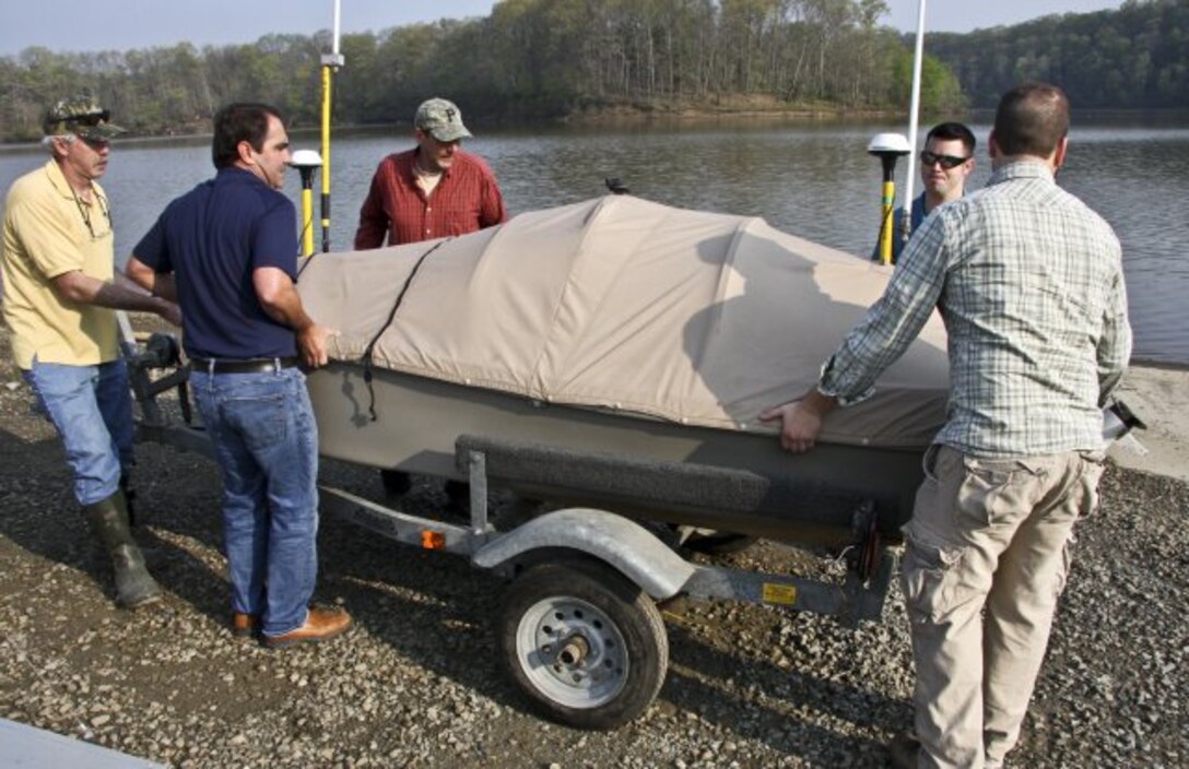 Pittsburgh district and ERDC staffs lift the USV off its trailer at the beginning of a day of surveying on Loyalhanna Lake in Western Pennsylvania.