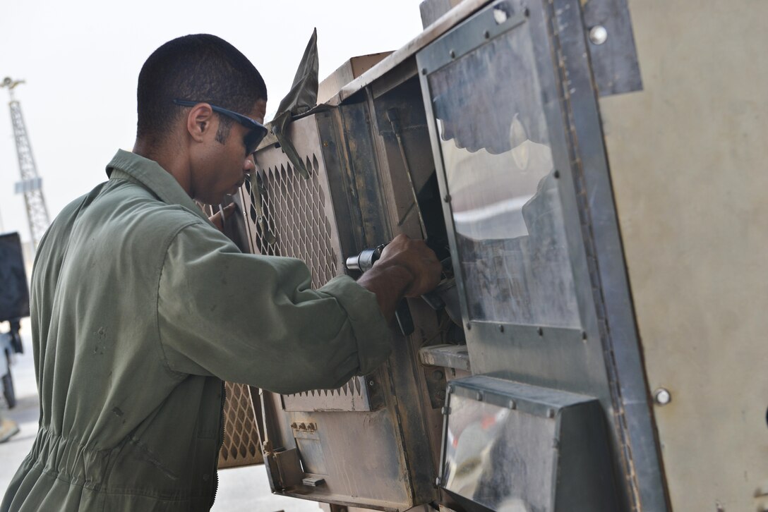 Senior Airman Udoka Addy, 379th Expeditionary Maintenance Squadron, applies rivets to a generator door during routine aerospace ground equipment repairs May 7, 2015 at Al Udeid Air Base, Qatar. Aircraft Ground Equipment airmen rotate shifts to ensure day and night operations are supplied with functioning equipment. These airmen endure heat that sometimes reaches above 100 degrees Fahrenheit causing them to sometimes work in black flag conditions. (U.S. Air Force photo by Staff Sgt. Alexandre Montes)  