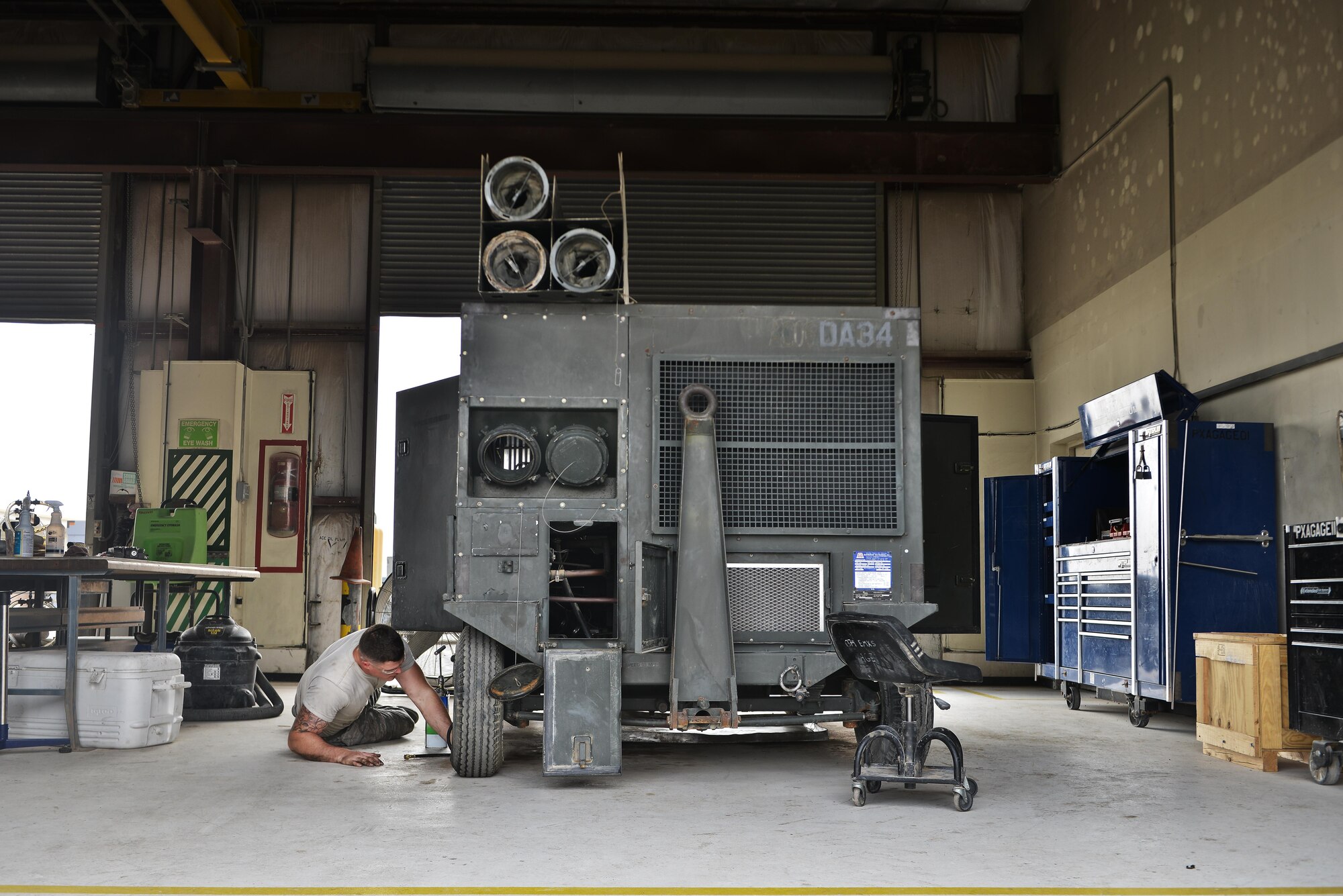 taff Sgt. Harrison Danforth, 379th Expeditionary Maintenance Squadron, prepares his work area to service an aircraft air conditioning unit May 7, 2015 at Al Udeid Air Base, Qatar. Due to the extreme heat and conditions in Qatar, maintenance airmen remain busy 24-hours a day ensuring that aircraft ground equipment support is working properly. (U.S. Air Force photo by Staff Sgt. Alexandre Montes)  