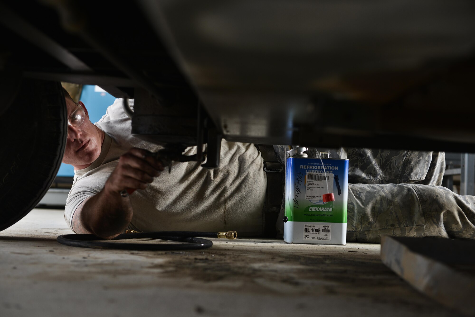 Staff Sgt. Harrison Danforth, 379th Expeditionary Maintenance Squadron, loosens a valve to relive pressure and replace refrigeration lubricant on an aircraft air conditioning unit May 7, 2015 at Al Udeid Air Base, Qatar. Aerospace Ground Equipment airmen are provided sheltered work areas for certain maintenance tasks that require them to either be underneath or above the equipment. This helps protect them from the extreme heat and weather that occurs in Qatar. (U.S. Air Force photo by Staff Sgt. Alexandre Montes)   