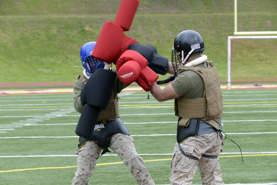 Marines fight using pugel sticks during the Marine Corps Martial Arts Program Gauntlet at Butler Stadium on May 1. Three Headquarters and Service Battalion teams competed in the two event gauntlet.