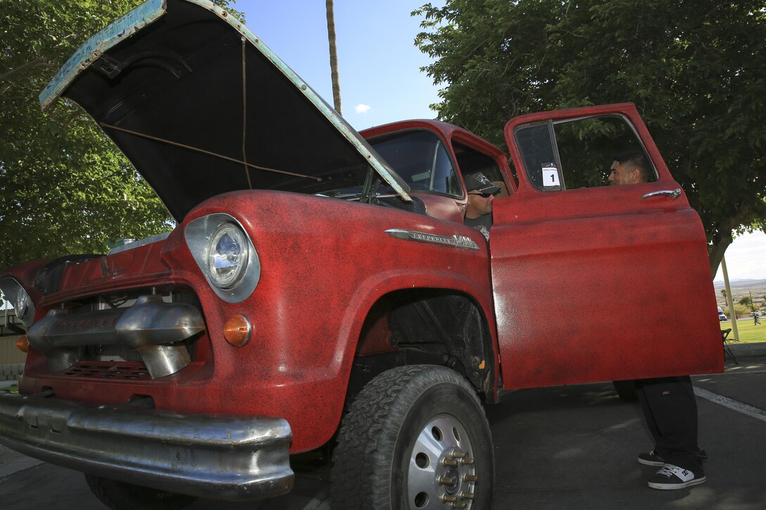 Retired Gunnery Sgt. Tim Warren and Lance Cpl. Elijah Goldsmith, cyber network operator, 1st Battalion, 5th Marine Regiment, display their 1956 Chevrolet 6400 during the Commanding General’s Car and Bike Show as part of the ‘We Salute You Fest’ at the Lance Cpl. Tory L. Gray Field, May 9, 2015. The vehicles competed for the People’s Choice Award and the event was open to all vehicle makes, models and years. (Official Marine Corps photo by Pfc. Levi Schultz/Released)