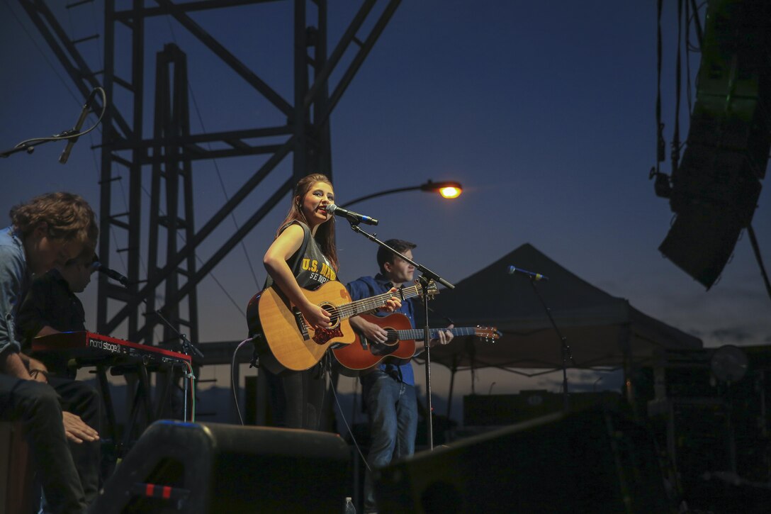 Caroline Kole, country music singer, performs for Marines, sailors and their families during the ‘We Salute You Fest’ at Lance Cpl. Torrey L. Gray Field, May 9, 2015. The event was free to all hands aboard the Combat Center. (Official Marine Corps photo by Pfc. Levi Schultz/Released)