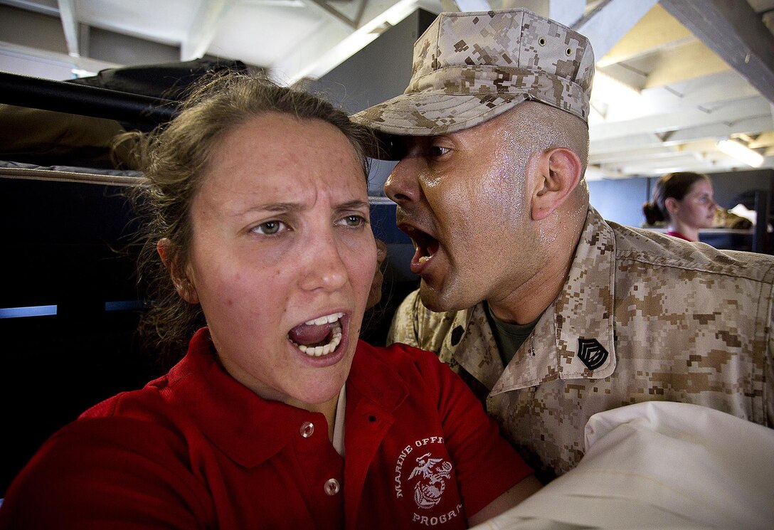 JOINT BASE LEWIS-MCCHORD, Wa. -- Anna Sigel, a Marine Corps officer candidate from Lancaster, Pennsylvania, responds to sergeant instructor Gunnery Sgt. Agustin Juradosegovia during Officer Candidates School preparation at Joint Base Lewis-McChord, Washington, May 8, 2015. During the three-day event, Seattle-based sergeant instructors and officer recruiters worked together to physically and mentally prepare candidates for the rigors of OCS, which the candidates will later attend aboard Marine Corps Base Quantico, Virginia. Juradosegovia is from Oxnard, California. (U.S. Marine Corps photo by Sgt. Reece Lodder)
