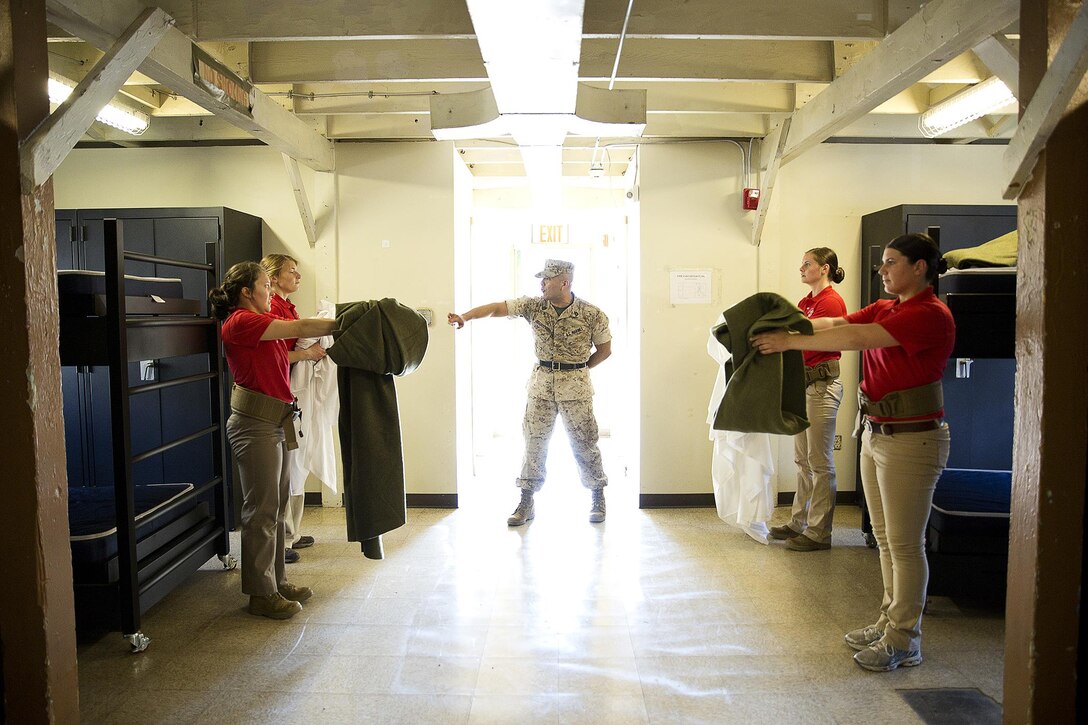 JOINT BASE LEWIS-MCCHORD, Wa. -- Gunnery Sgt. Agustin Juradosegovia, a sergeant instructor from Oxnard, California, prepares Marine Corps officer candidates to make their beds during Officer Candidates School preparation at Joint Base Lewis-McChord, Washington, May 8, 2015. During the three-day event, Seattle-based sergeant instructors and officer recruiters worked together to physically and mentally prepare candidates for the rigors of OCS, which the candidates will later attend aboard Marine Corps Base Quantico, Virginia. (U.S. Marine Corps photo by Sgt. Reece Lodder)